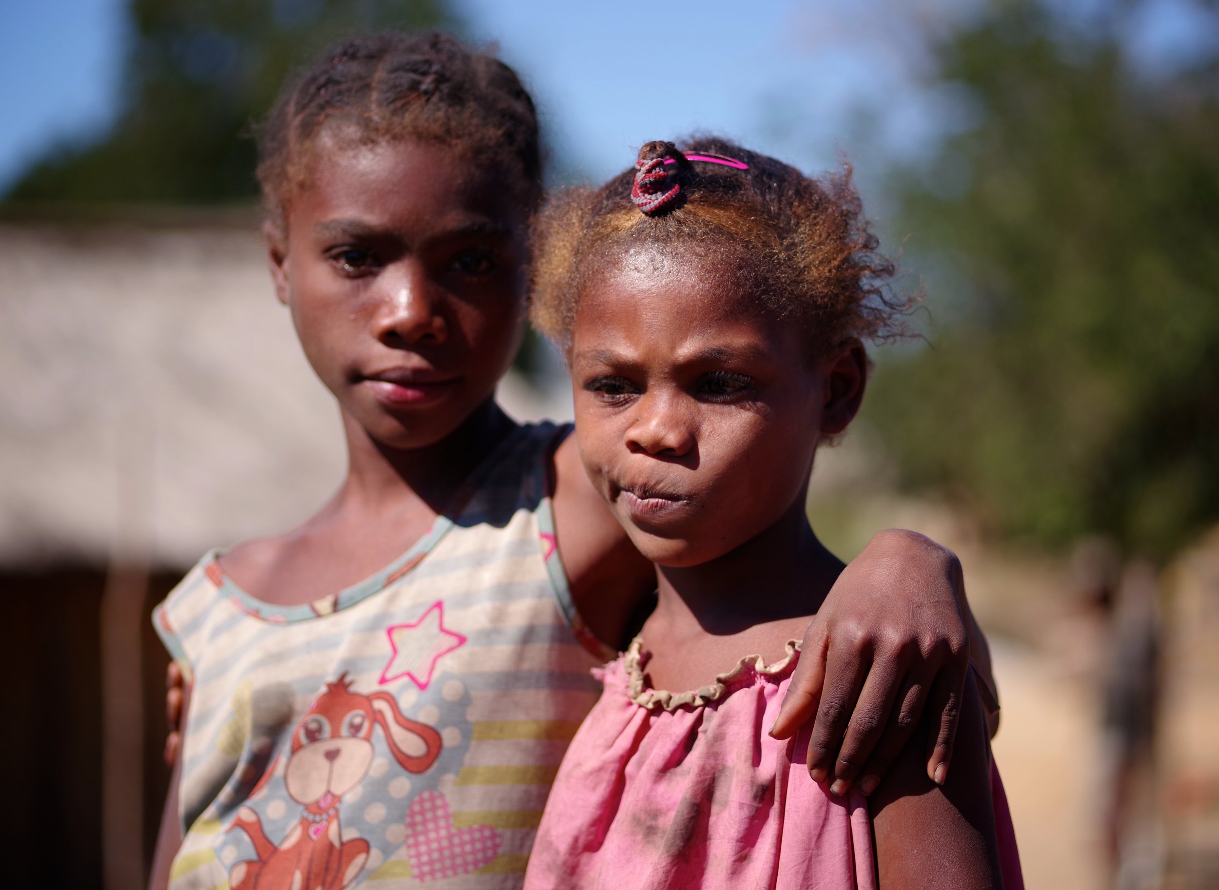 Fanofi and Tiana Sisters in arms. Much of Madagascar's population still relies upon subsistence farming and these two girls laid down their shovels for a short break.