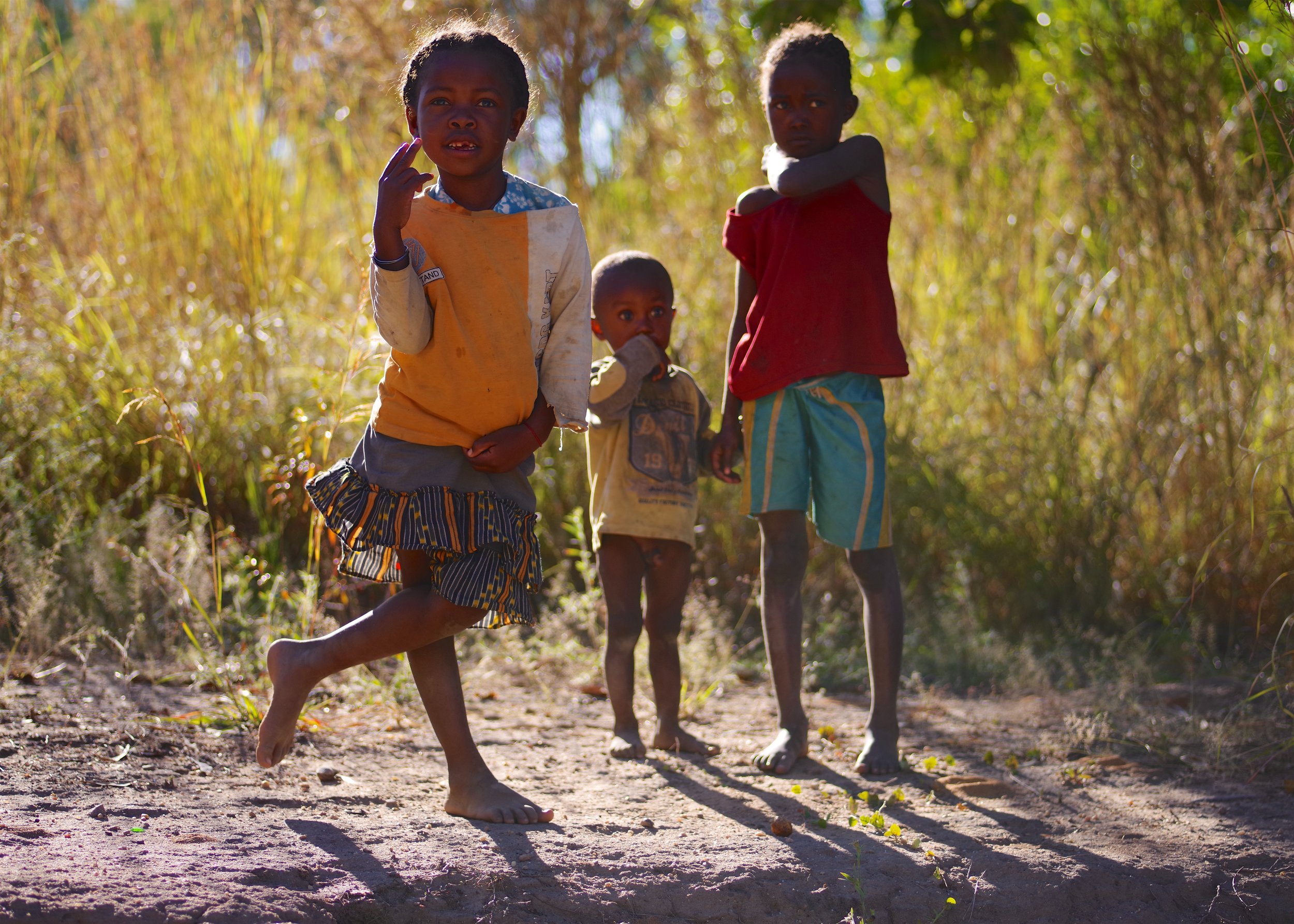Mafana and her Brothers The two boys looked on cautiously as their older sister posed in front of the camera, seemingly without a care in the world.