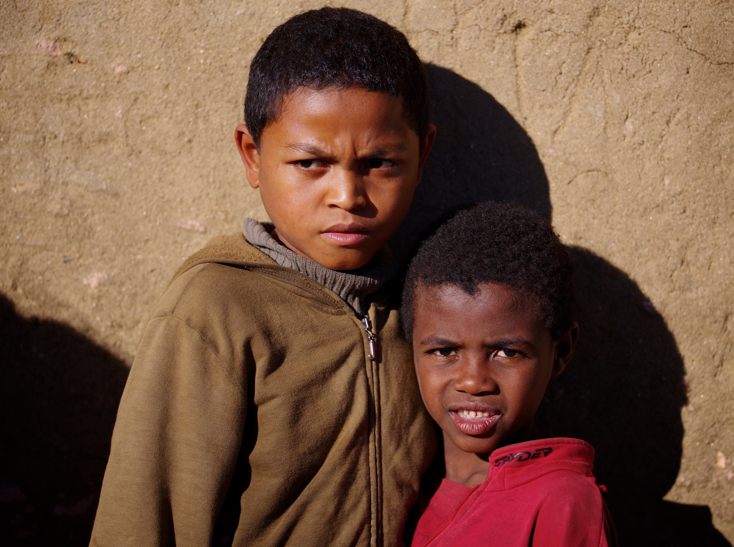 Husso and Tomasi An older friend, keeping an eye out for any trouble on the side, shares a photograph with young Tomasi.