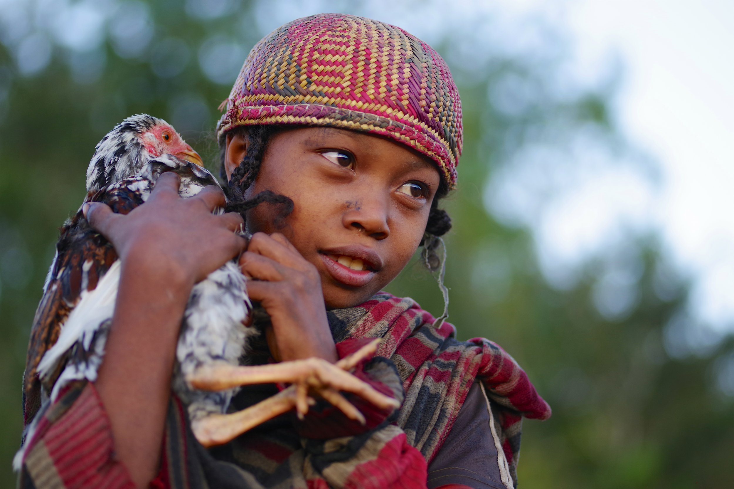 Marie The soft clucking of her chicken provides some source of comfort for this young girl, so very shy of the camera.