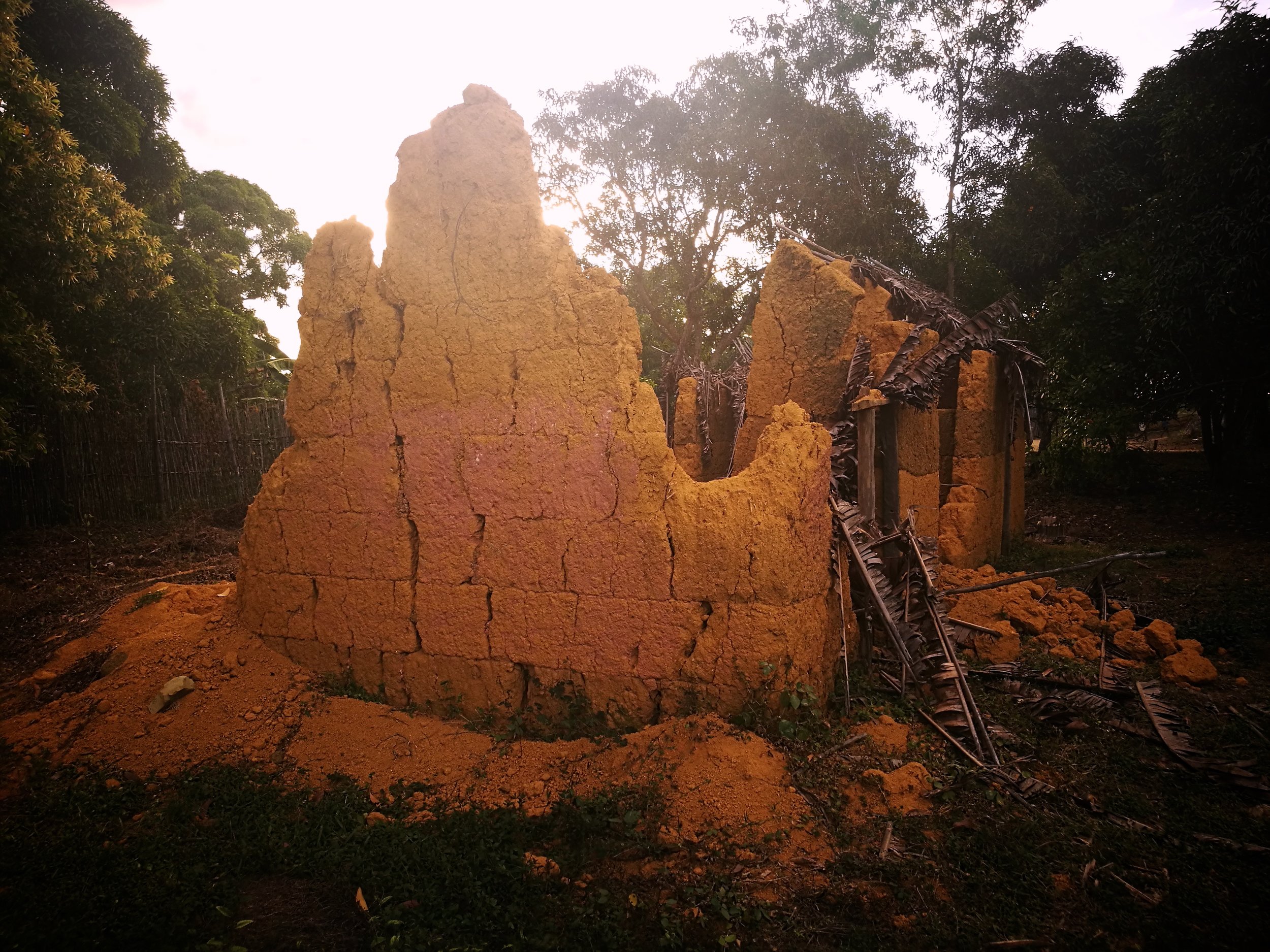 Termite Temple The ruins of a clay church lie abandoned in a forest clearing. They gave me the impression of a huge termite mound.