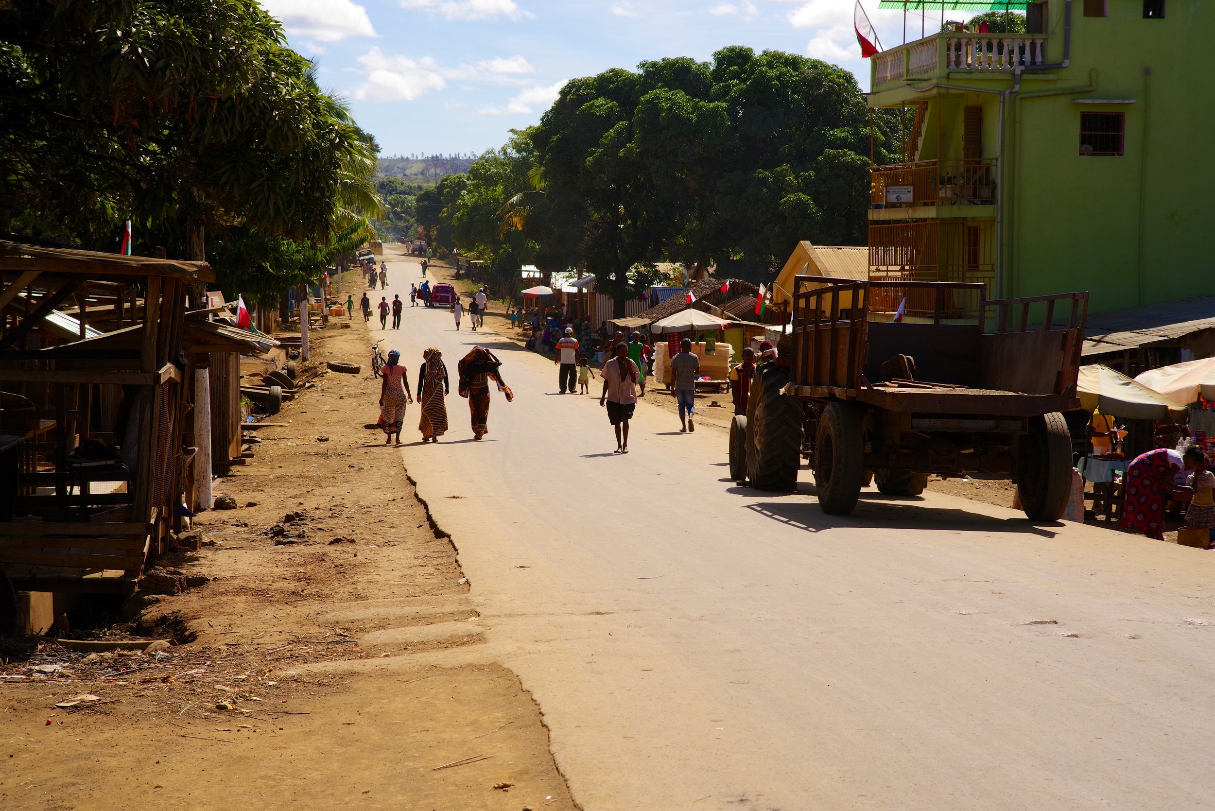 Busy Road The main highway is filled with people and machines alike as everybody rushes to and from the market square.