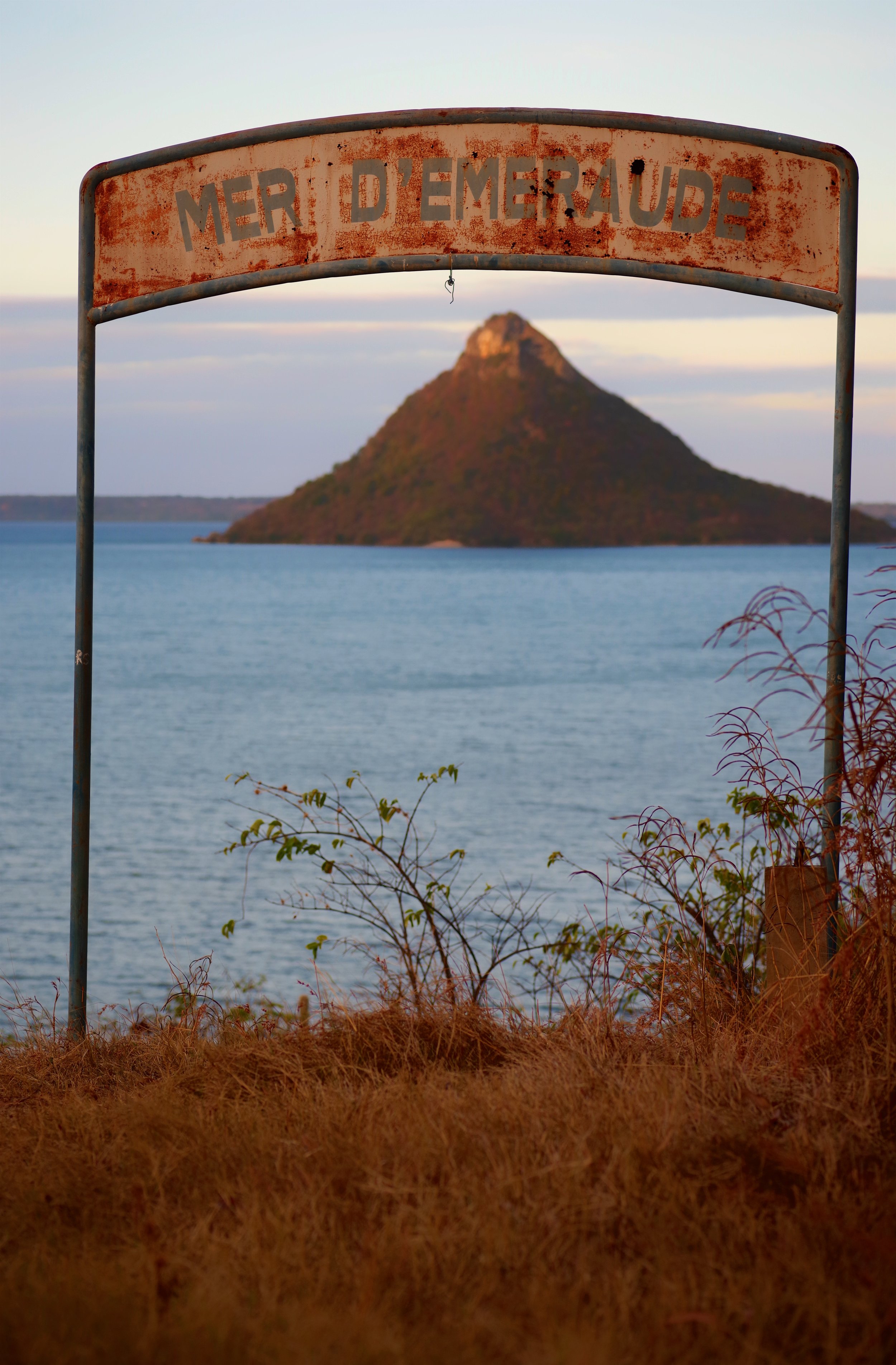 Sacred Rock A conical rock, sacred to local tribes, juts out of the calm waters of a bay in Northern Madagascar.