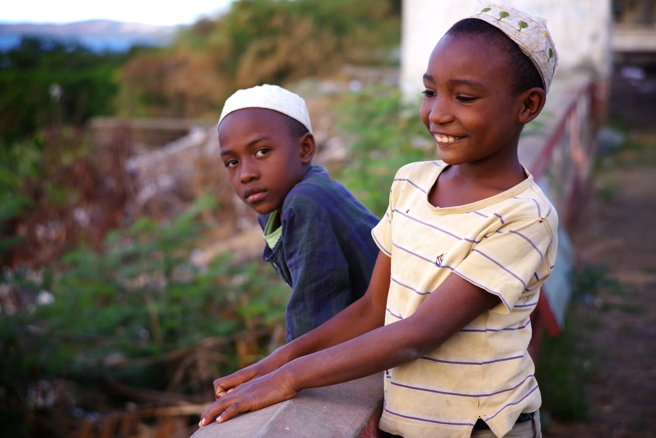 Muslim Boys, Diego Suarez Two brothers lean over the sacred walls of one of the oldest mosques in the Indian Ocean. The whole north of Madagascar felt dilapidated. A place forgotten by time.
