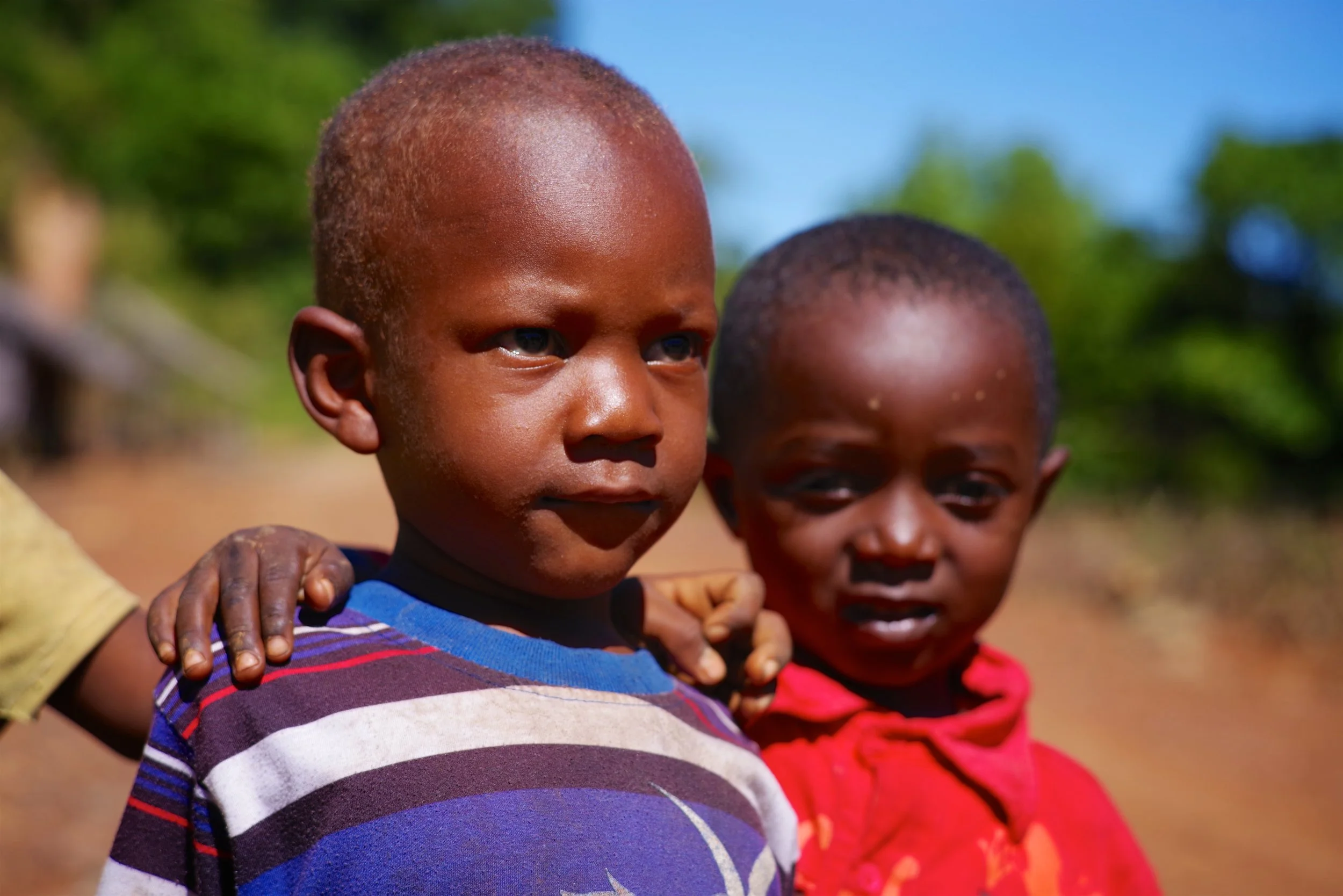 Anju and Wilfred Young boys play on the edge of a dirt road in southern Nosy Be. Children on the offshore islands of Madagascar live rural lives. Wooden toys and beach combing objects are rare treasures for them.