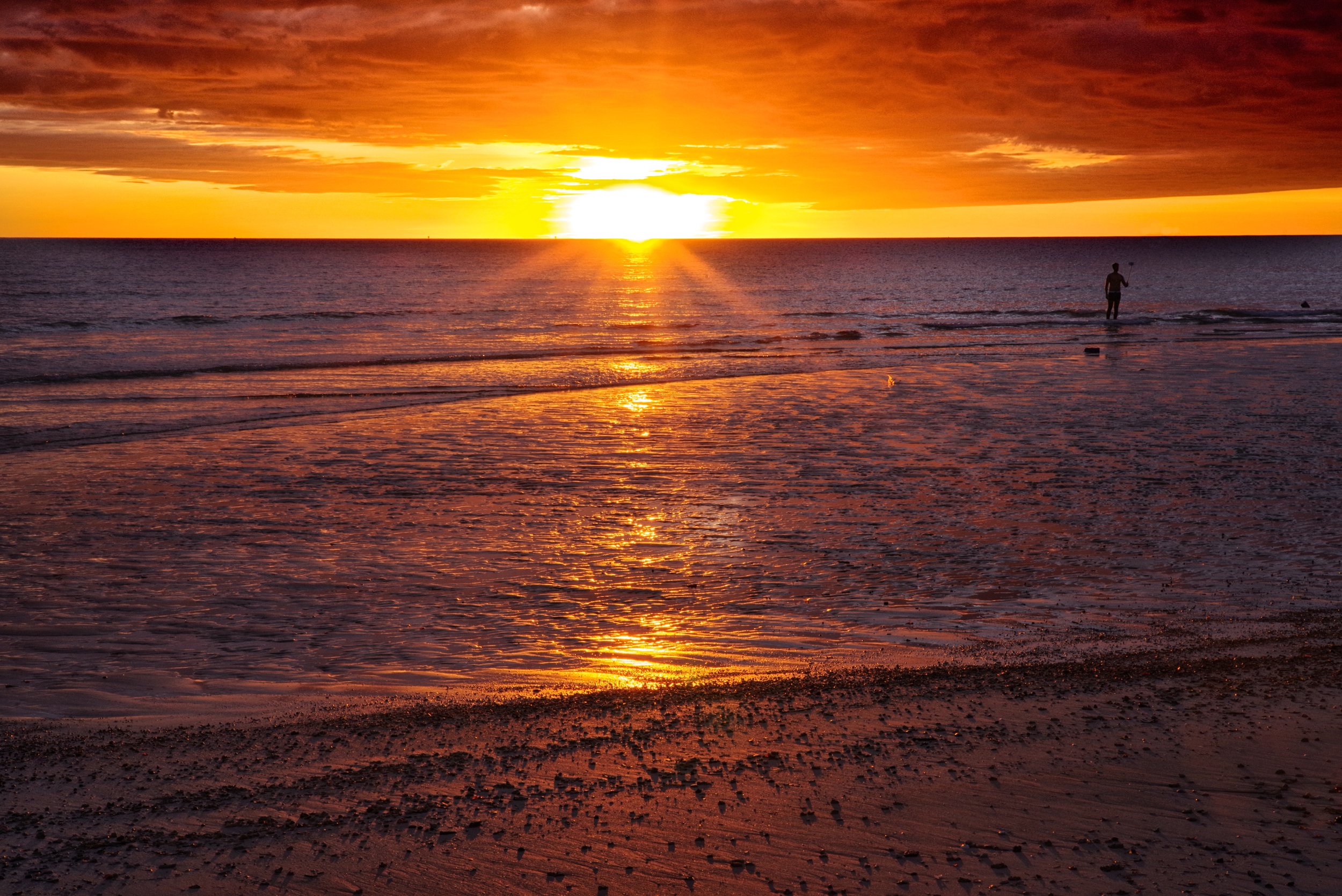 A Peaceful Bay Long stretches of dark sand catch the fiery rays of sunlight as everything turns to gold in Nosy Be.