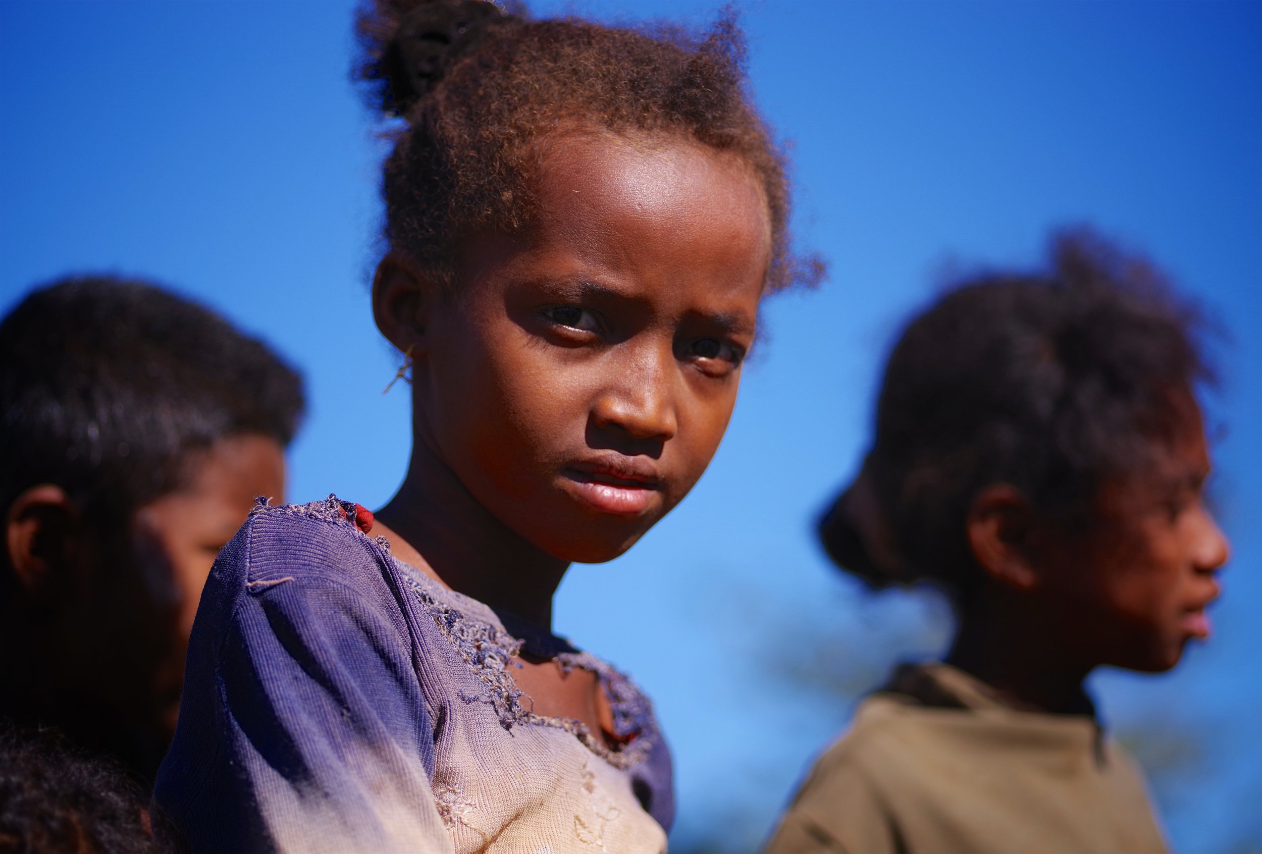 The Long Road Home These children belong to a group of semi-nomadic people, traveling across the scorched deserts of southern Madagascar in search of more fertile valleys.