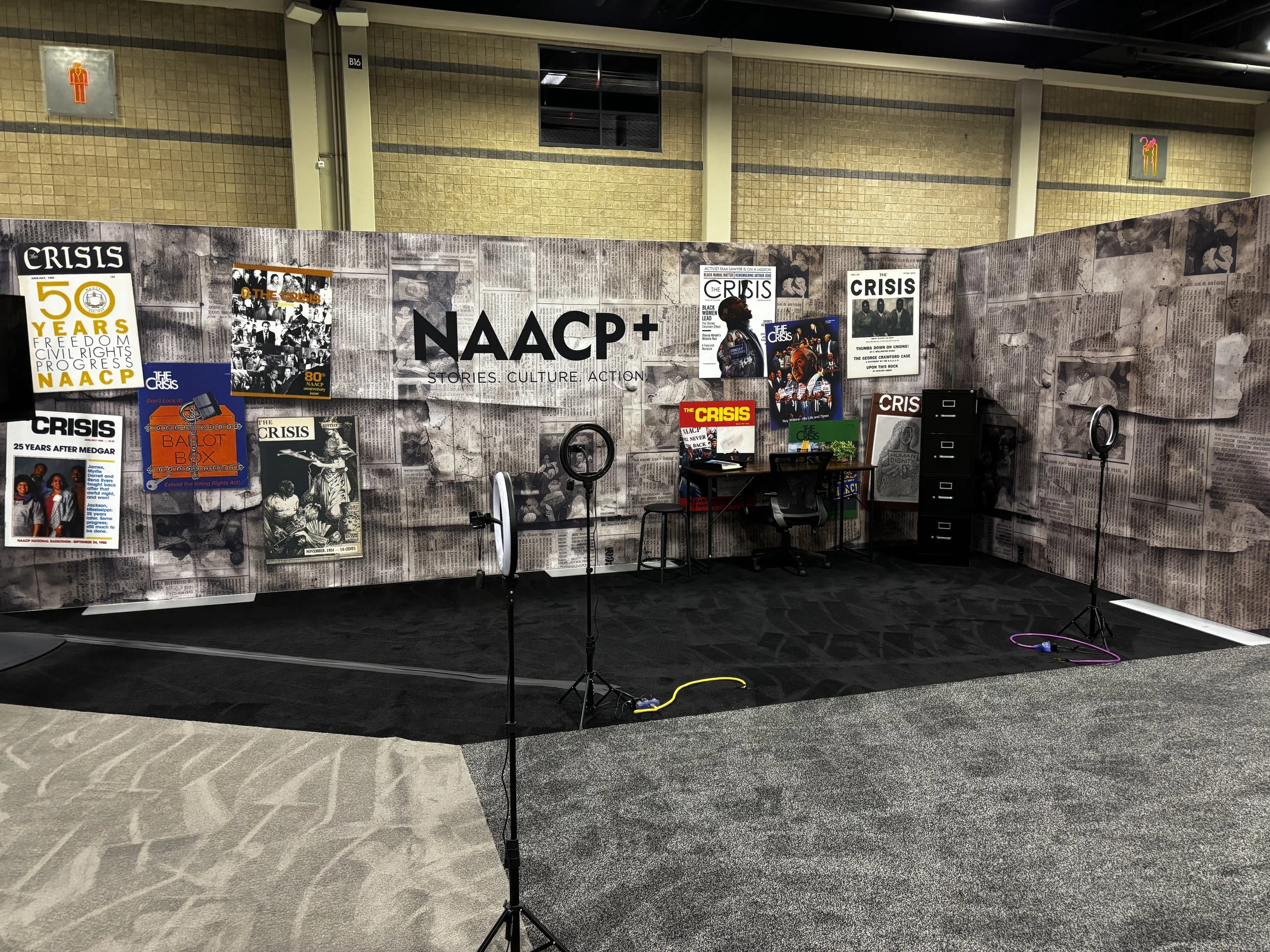  The final section of  Protest Headquarters  featured a striking wall treatment that layered history and design. A collage of vintage newspapers created a textured backdrop, symbolizing the ongoing story of progress and activism. Overlaid on top were