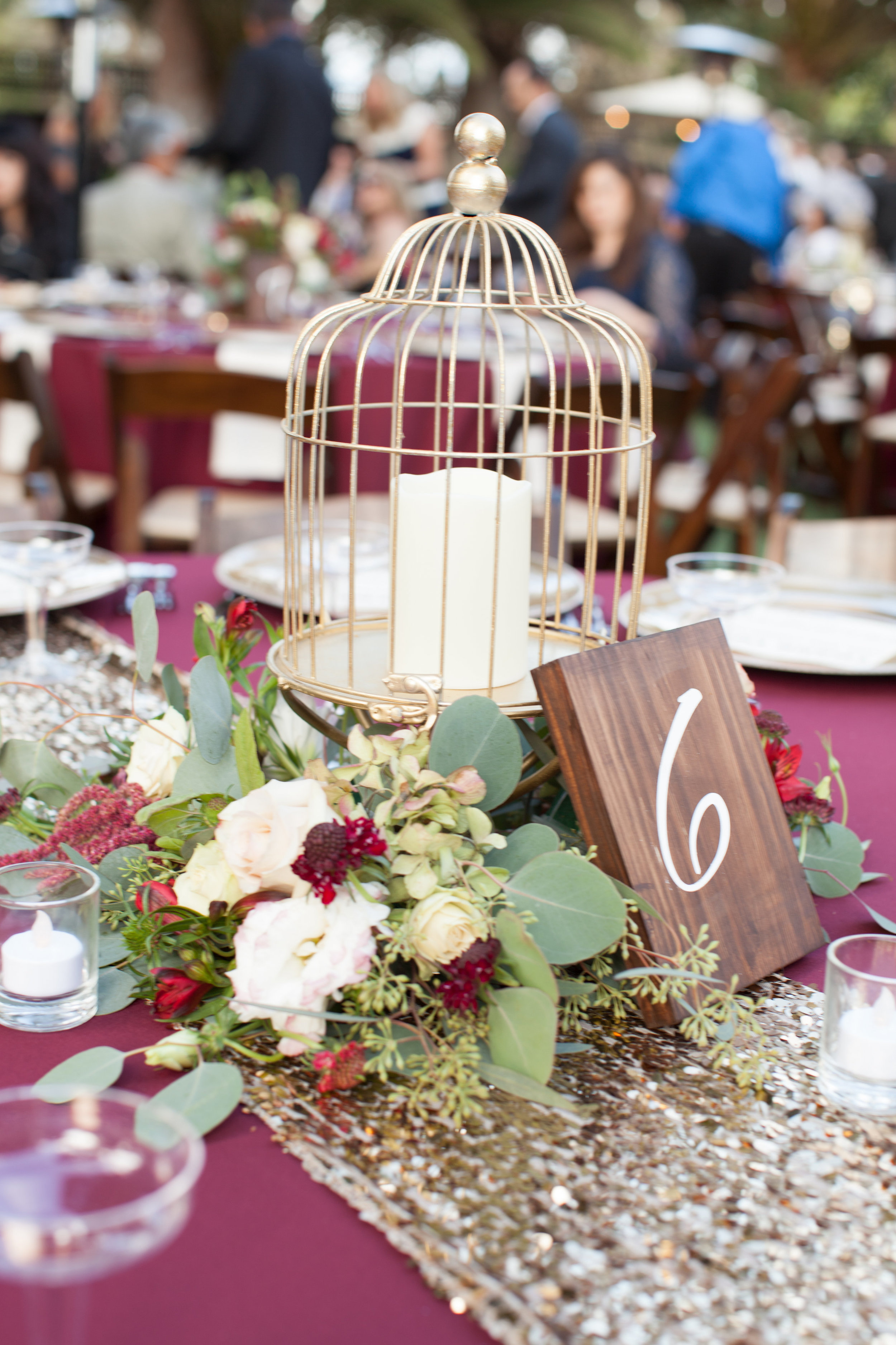 Gold birdcages, burgundy flowers & wood table signs by Down Emery Lane.