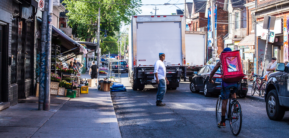 Bike courier vs delivery truck in Kensington Market, Toronto. 