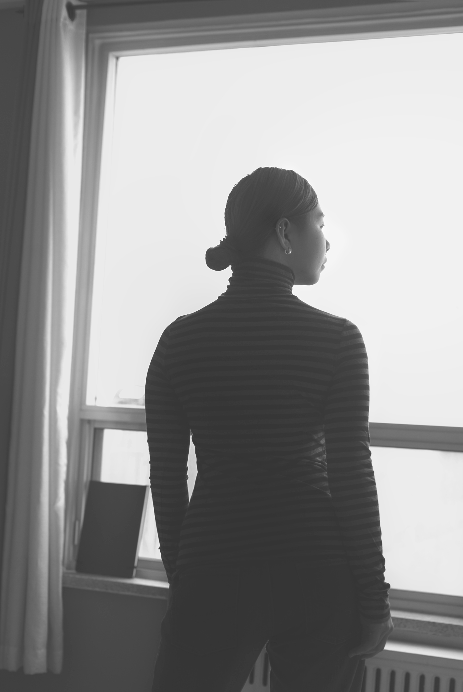 Vietnam born, Oakville Artist Zarah Nguyen. Black and white artist profile portrait.