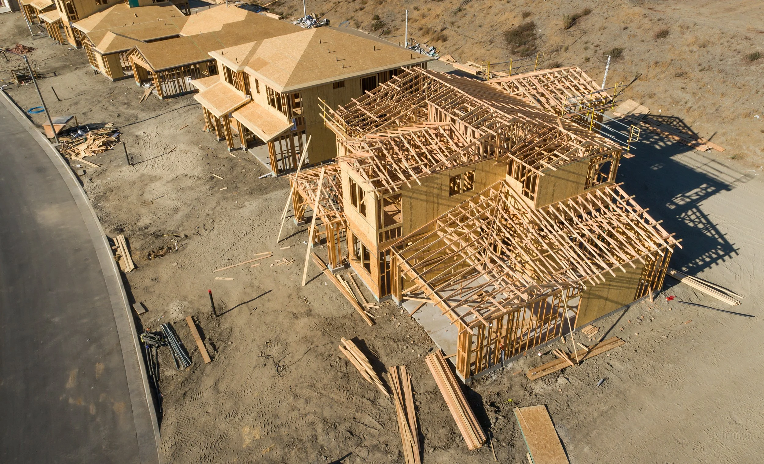 Drone photograph documenting residential construction progress during framing