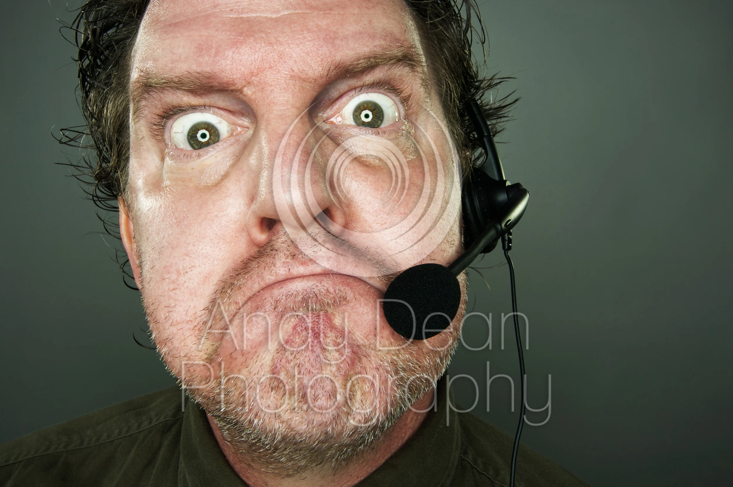   Frowning man with telephone headset.  