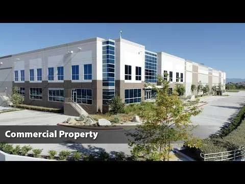 Panning Aerial Flight In Front of New Industrial Commercial Building.