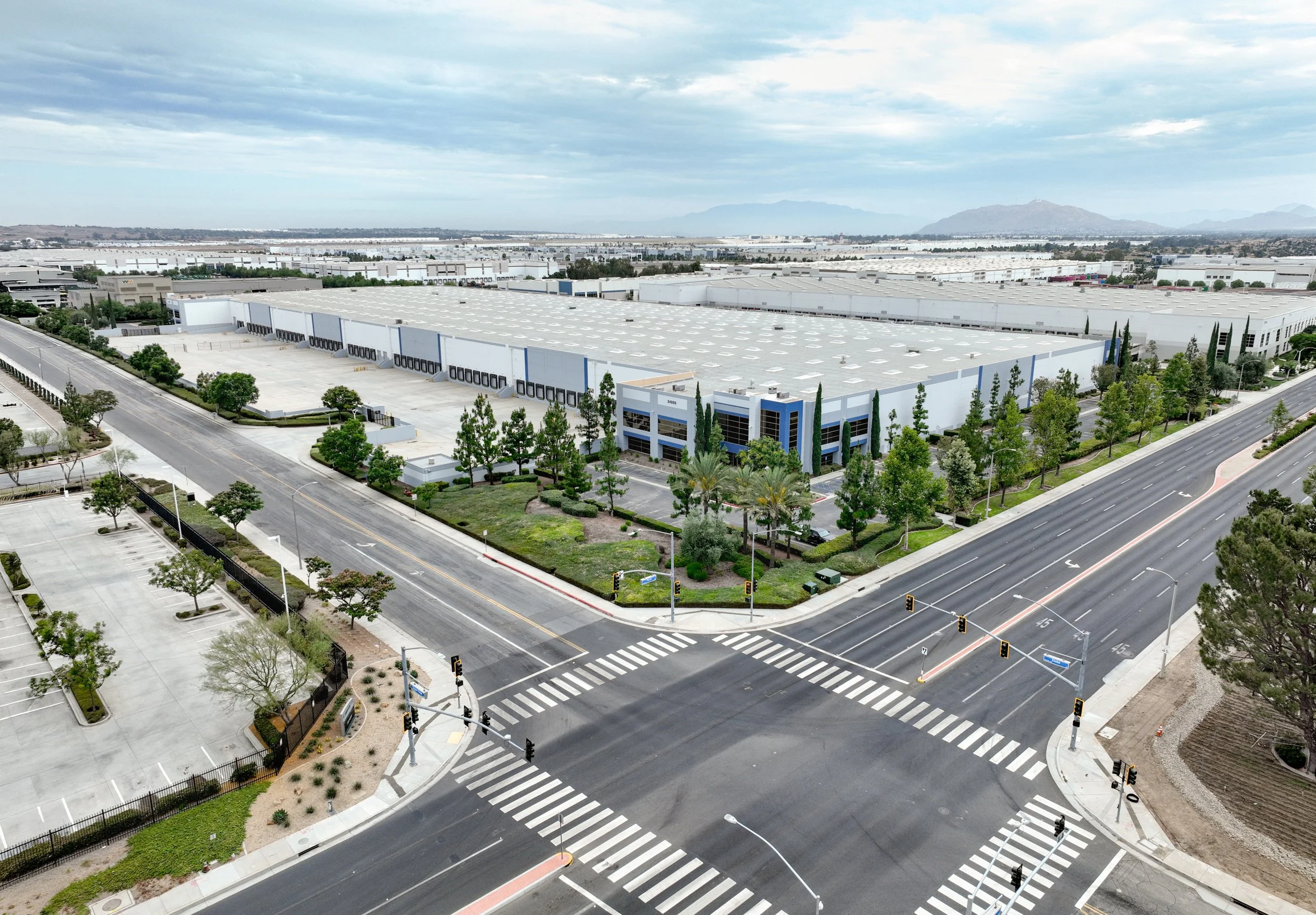 Clean aerial imagery showcases property scale, architecture, access, street frontage, and surrounding context.