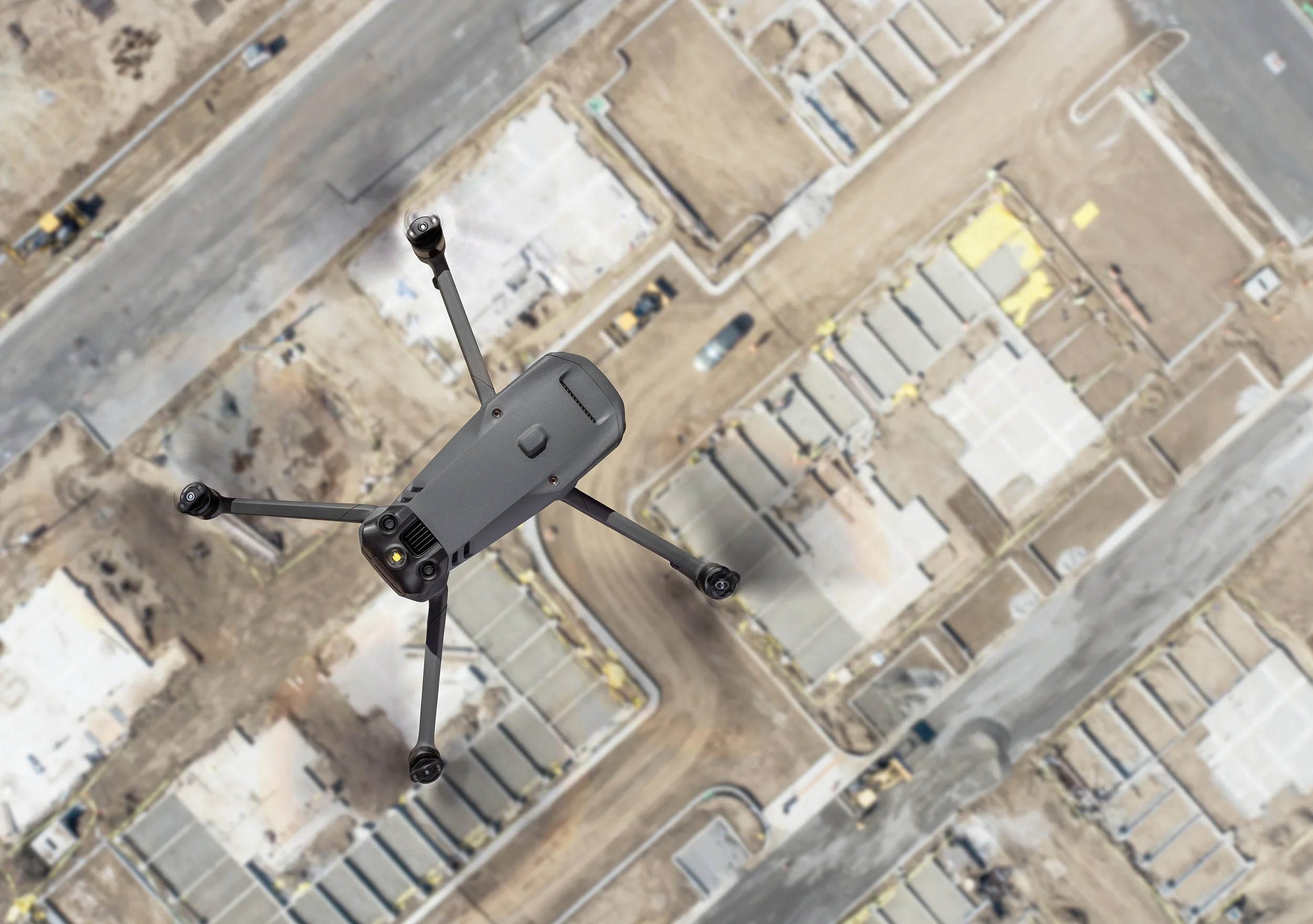 Drone flying above an active construction project providing aerial photography and documentation services