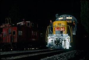  Looking like a scene from Coal Country, L&amp;N 1315 is lit up parked next to an N&amp;W caboose. 