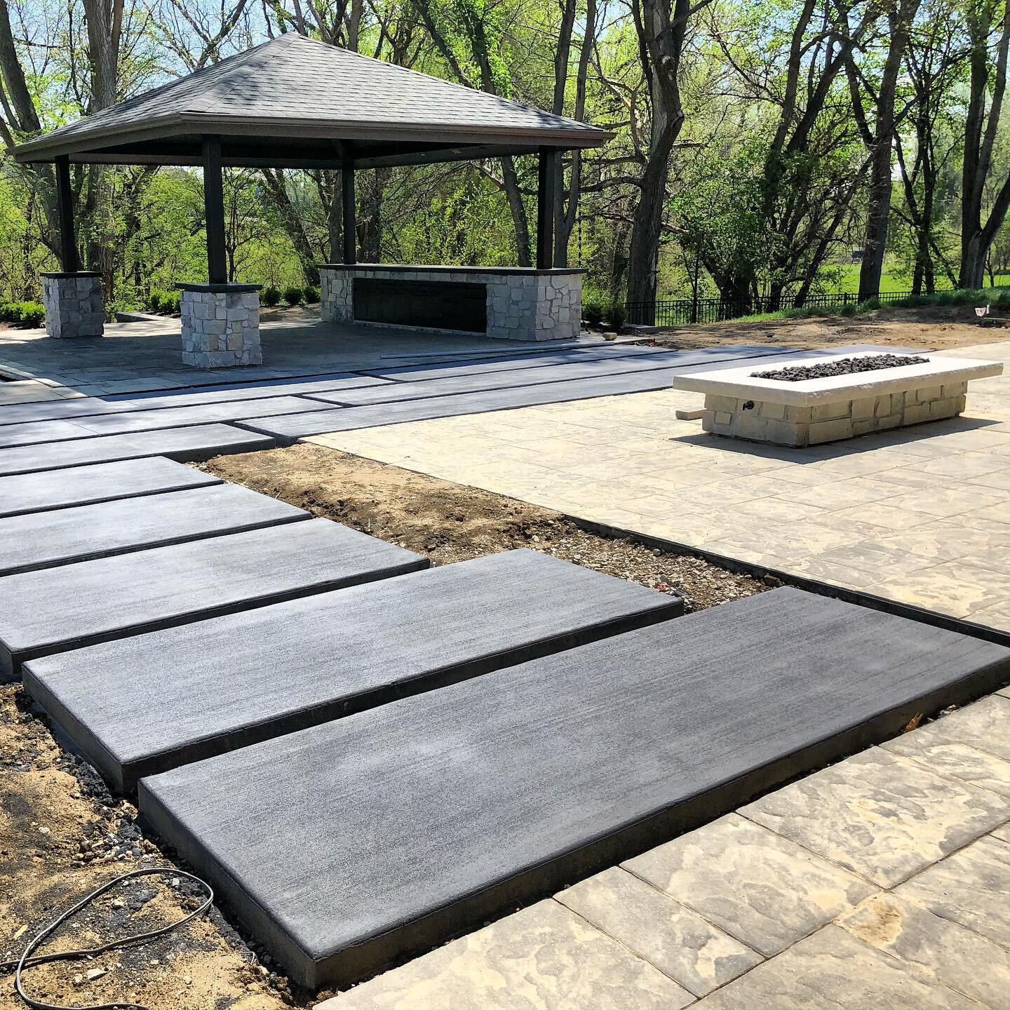 For this outdoor space, poured concrete slabs offer a unique journey linking paver patio and pool pavilion.  Next, the garden will be installed.  Often overlooked, the garden design is the most important element to a well designed outdoor space.  Pro