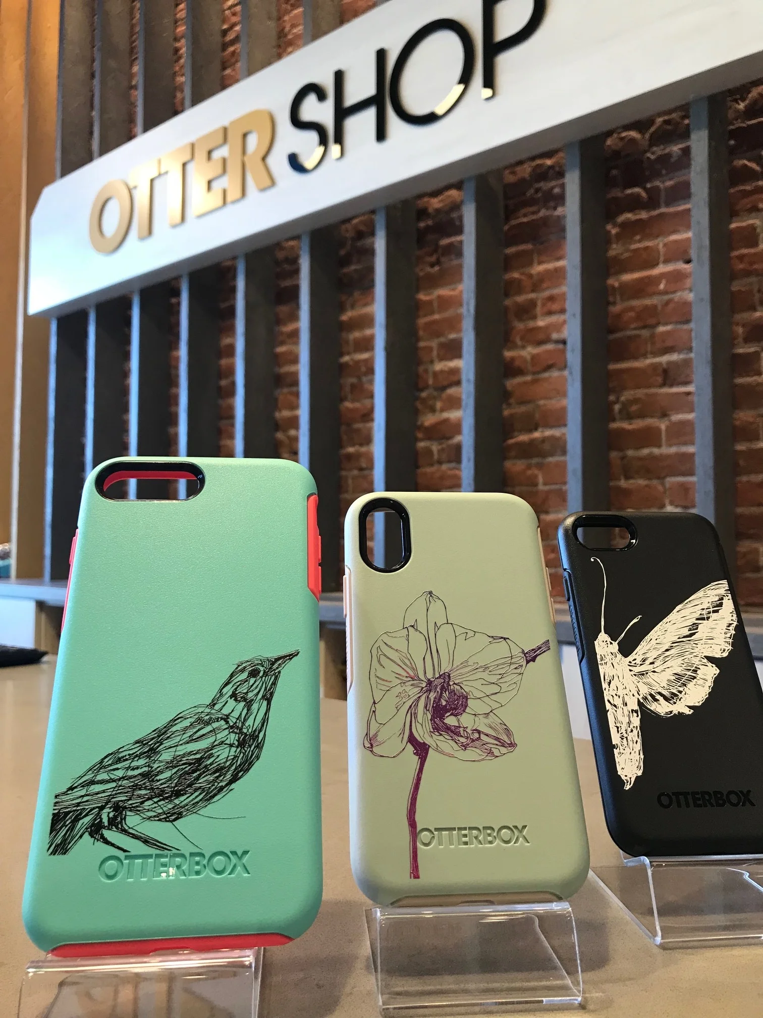 Three drawings by Melissa Carmon on Otterbox cases