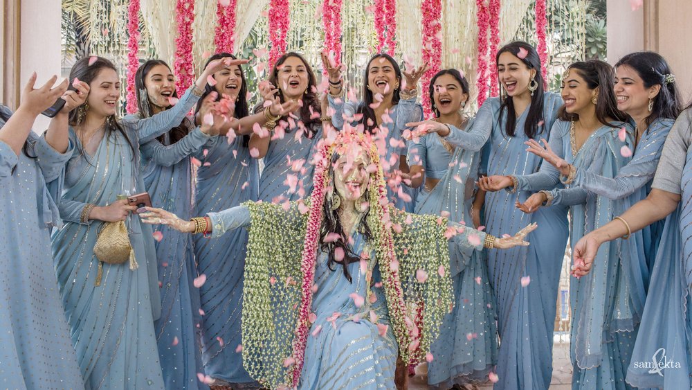 All of her bridesmaids joined in to rain down flower petals on her