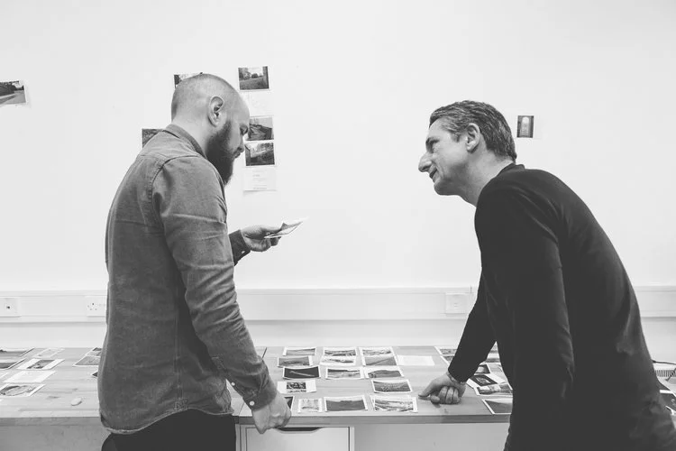 Designer Vinny Gregan and photographer Dara McGrath working on image selection and sequencing for his photobook ''Project Cleansweep'.