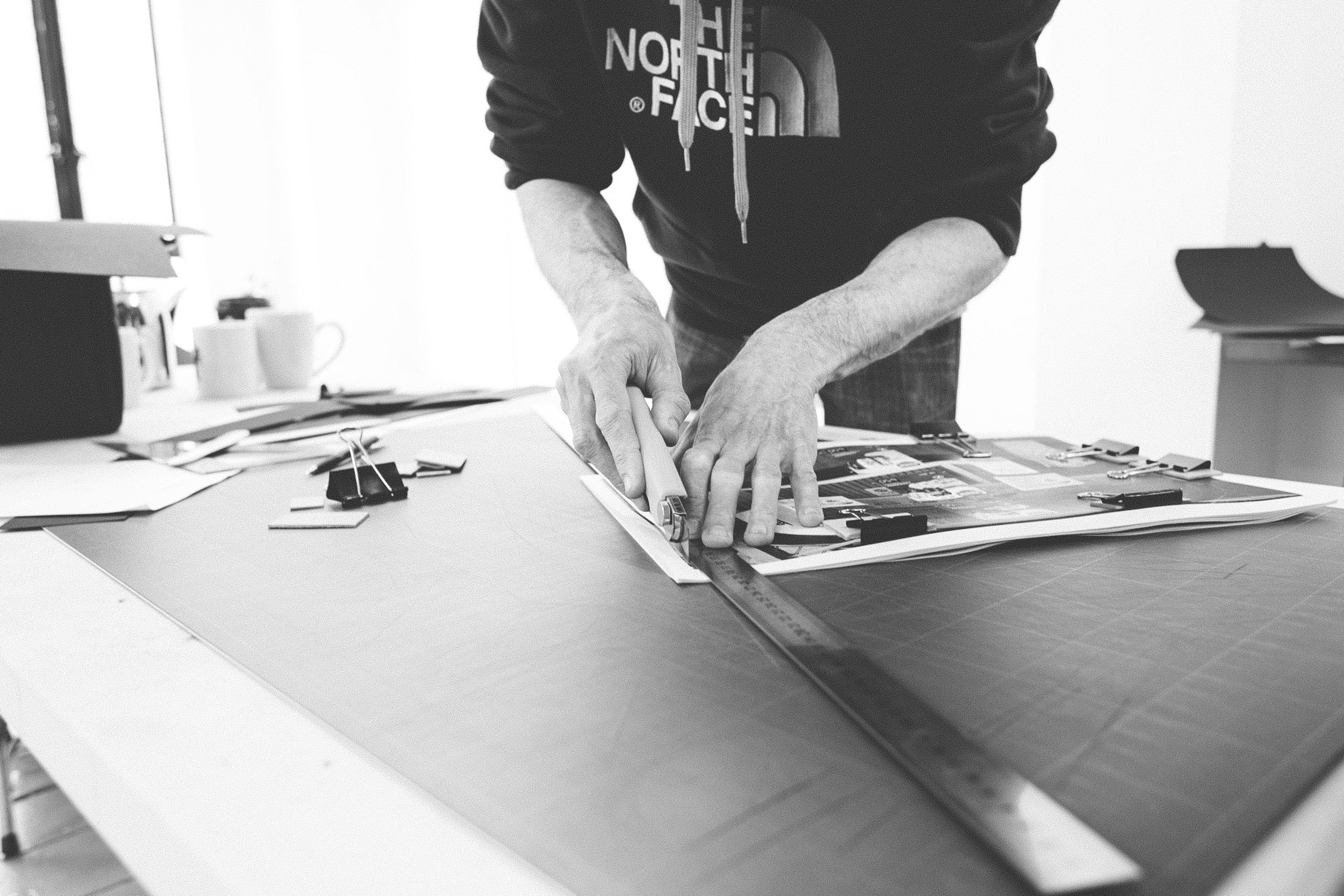 Read That Image member Barry Keogh cutting down printed sheets in preparation for photobook dummy binding during Make a Photobook workshop in Temple Bar Gallery and Studios.