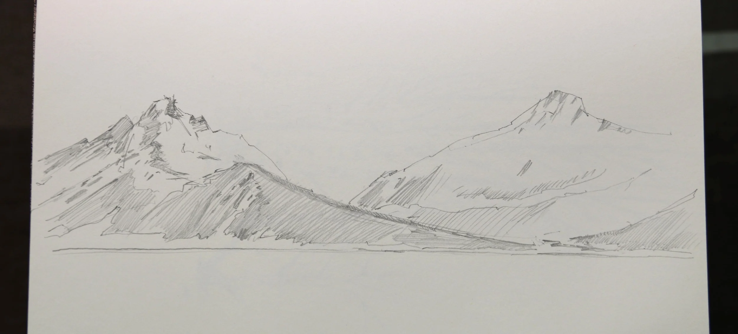 Silhouettes of the snow covered hills.