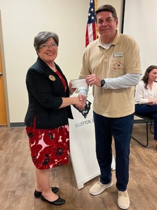  Steve McCaskey presents check to the Marine Corps Community Services 