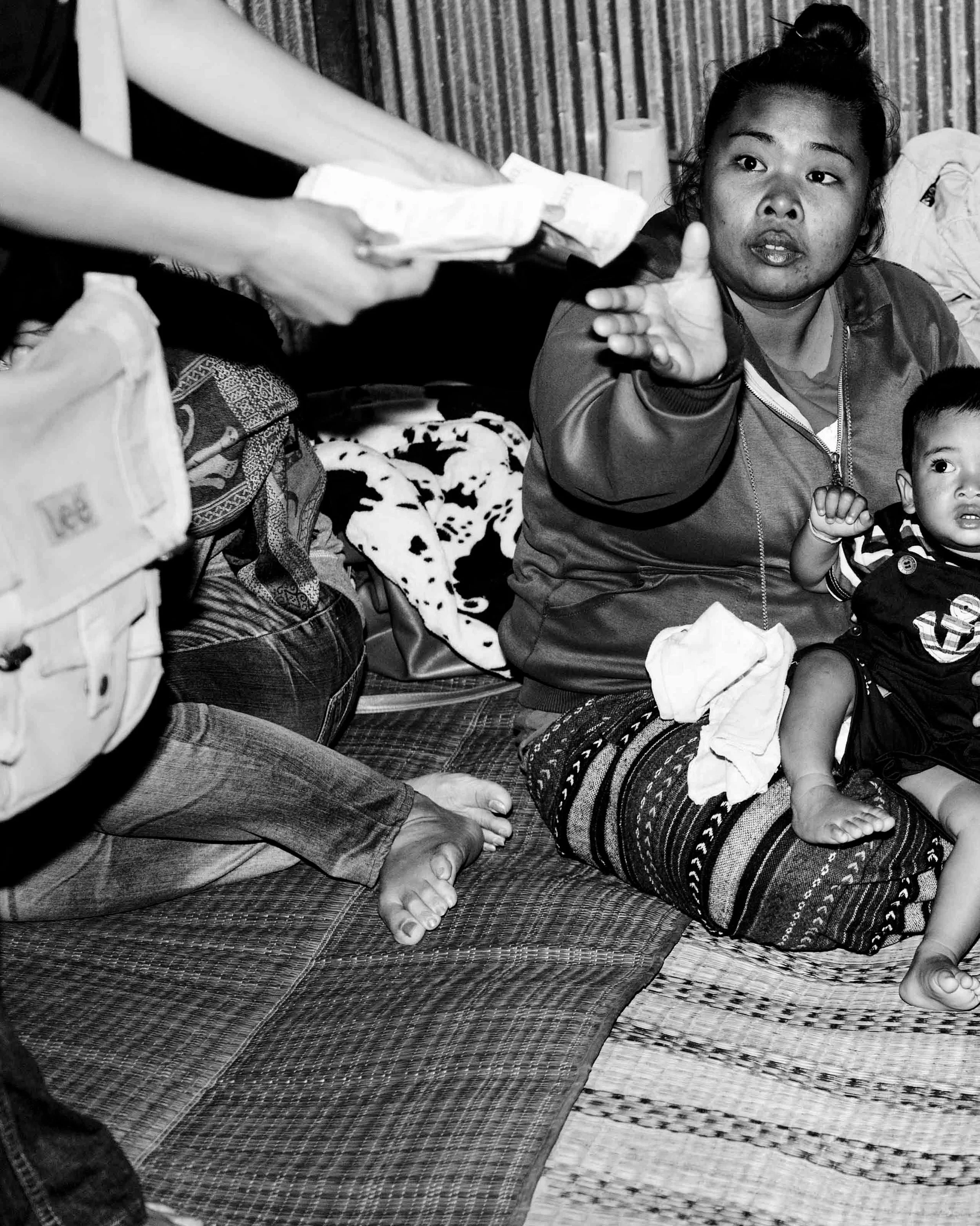 A mother receives the purse from her son&rsquo;s late-night fight in Isaan. The money is welcome, but in rural Thailand it rarely stretches far. Income is more often made or lost through gambling than through the fight purse itself. #muaythai