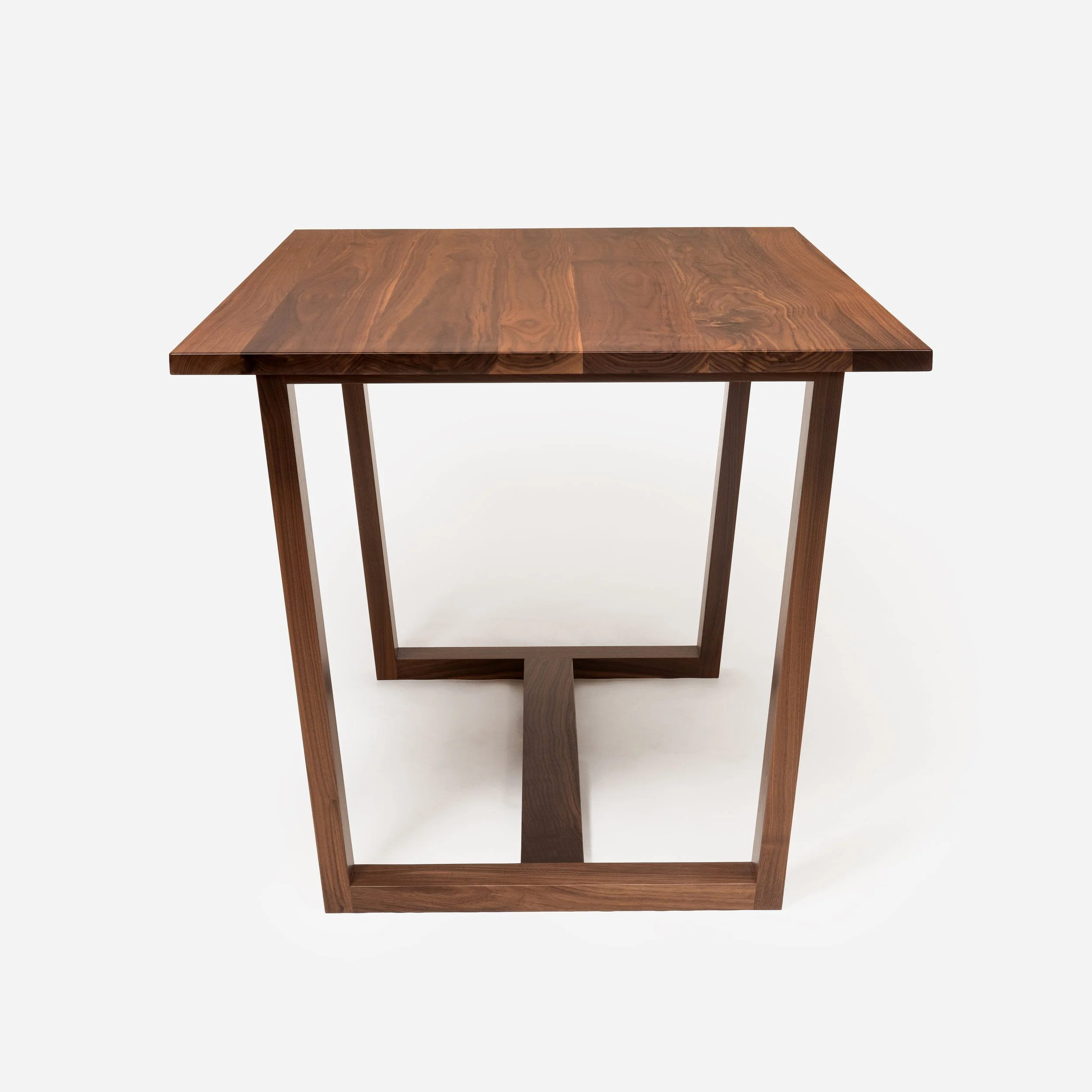 Handcrafted Arden Table made from walnut wood with tapered base, modern design, and expert craftsmanship, blending strength and elegance, made in Milwaukee.
