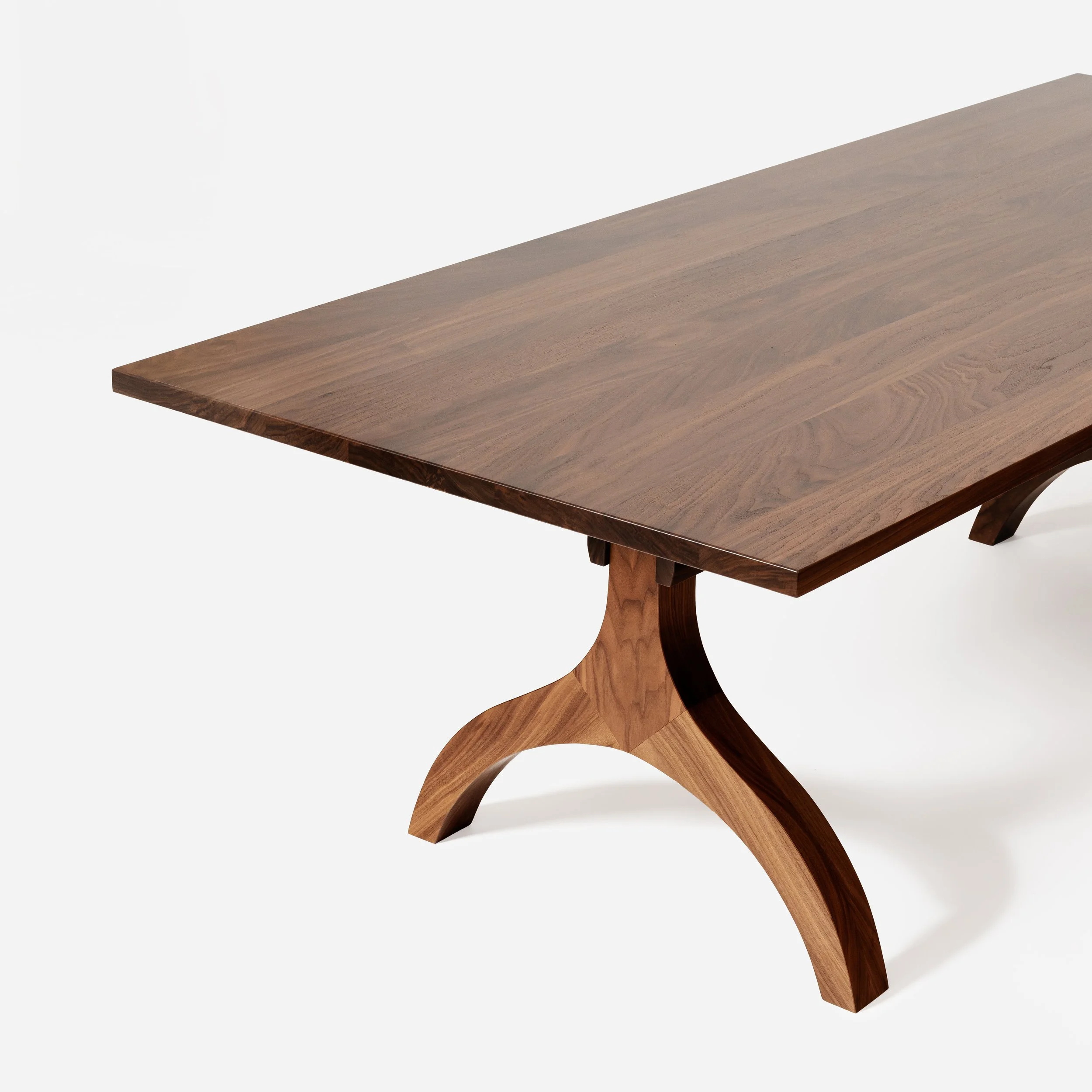 A cropped, close-up architectural shot of the table's base and joinery
