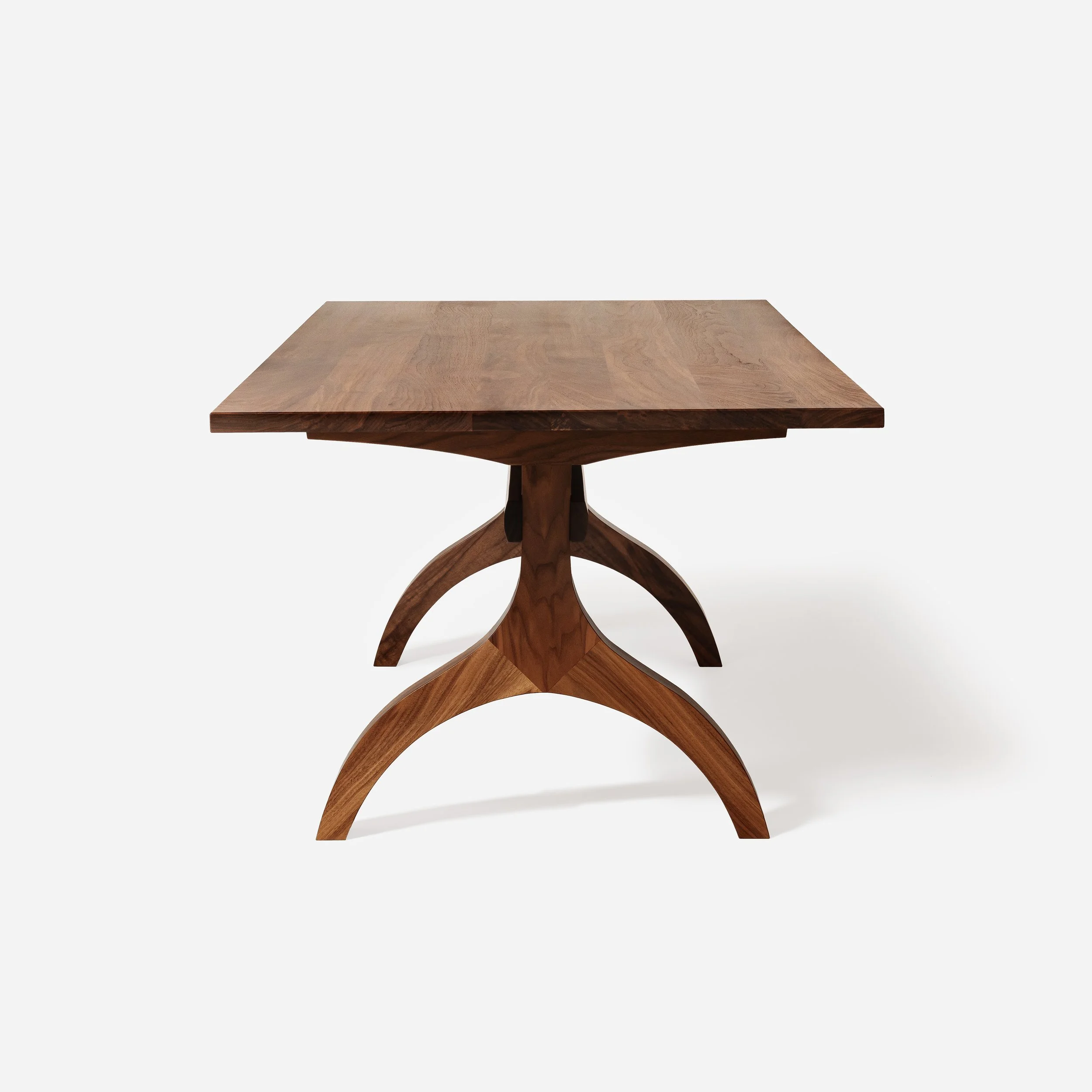 A direct, head-on end shot of the solid walnut dining table