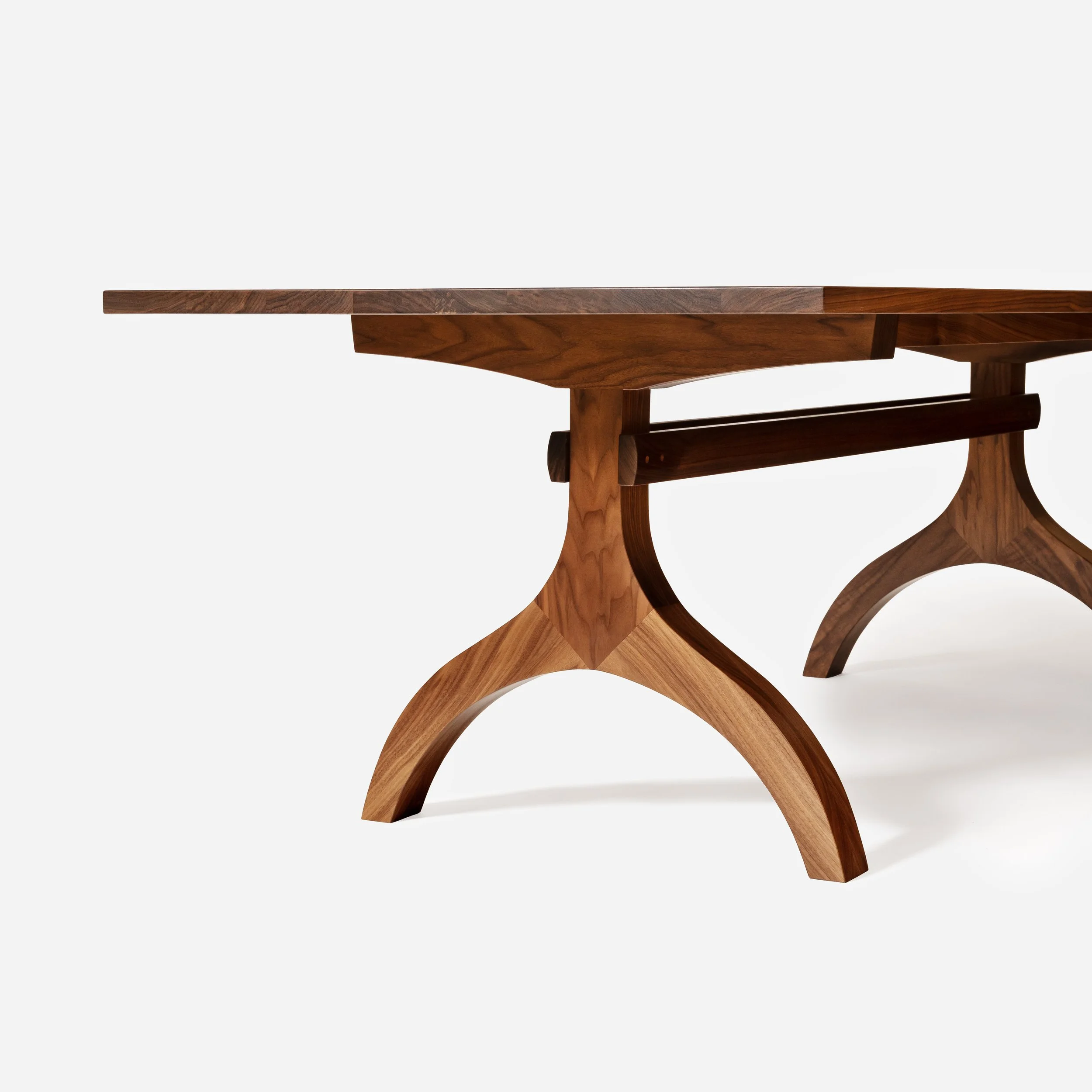 A high-angle, close-up studio shot focusing on one corner of the dining table