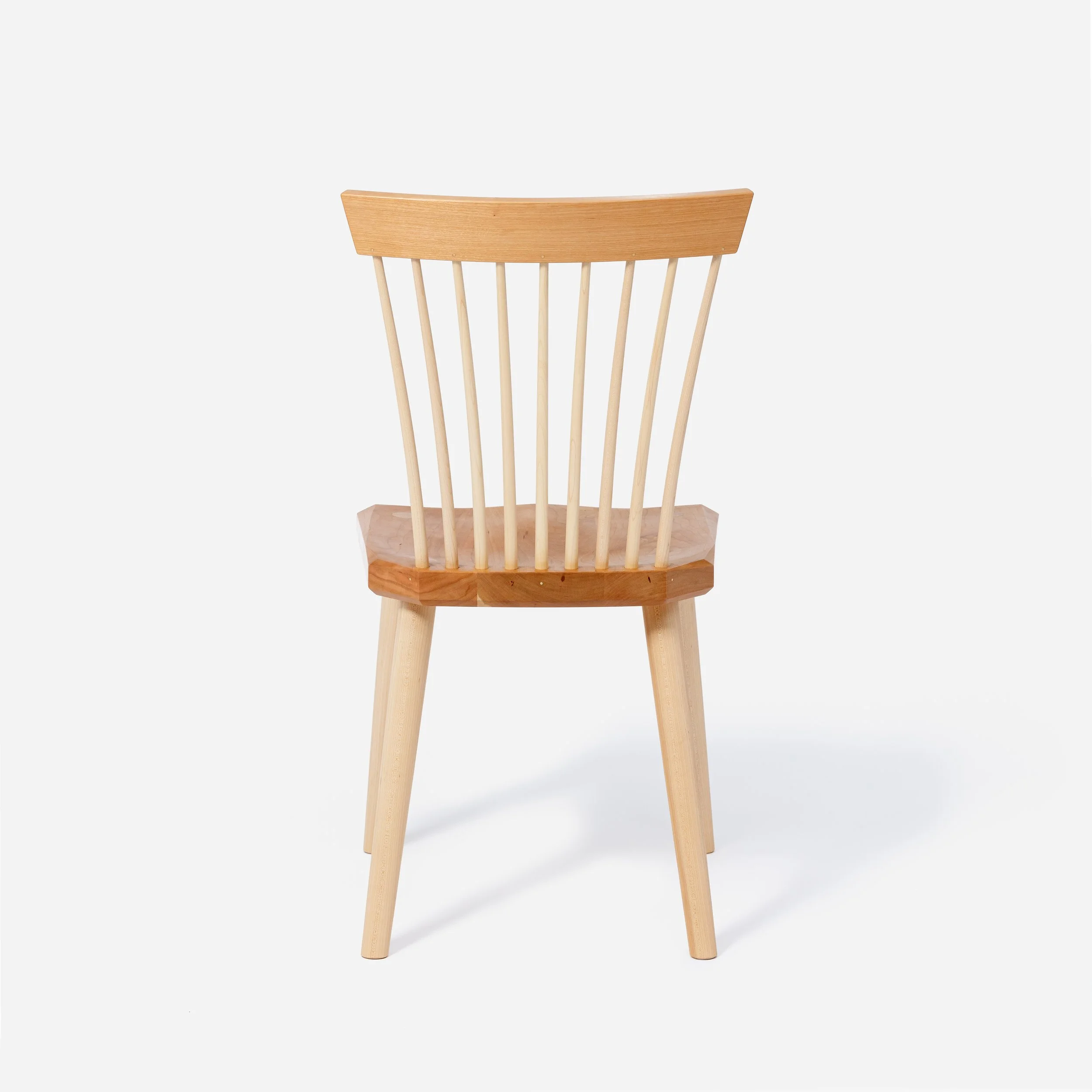 Handcrafted Spindle Back Chair made from cherry wood, offering a sturdy base and timeless aesthetic, made in Milwaukee.