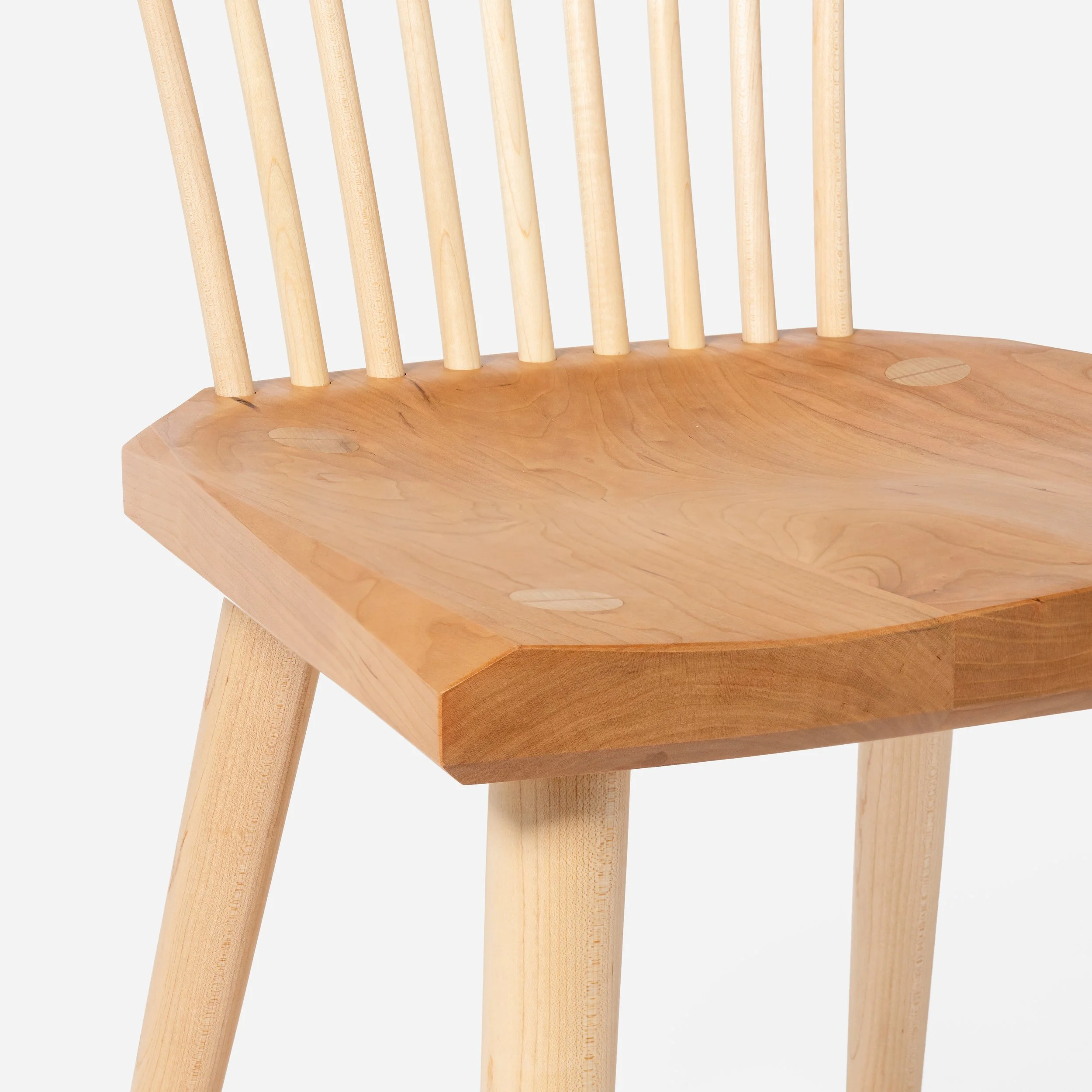 Handcrafted Spindle Back Chair made from cherry wood, offering a sturdy base and timeless aesthetic, made in Milwaukee.