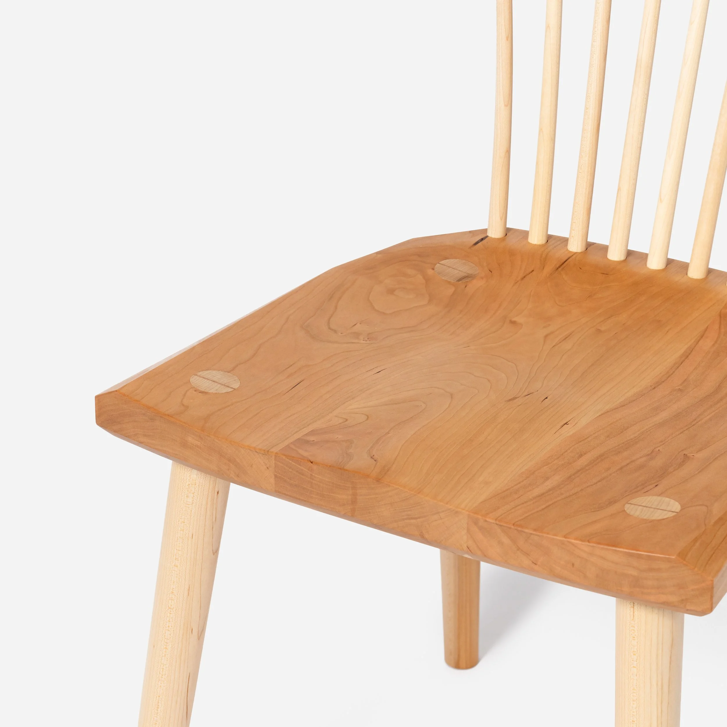 Handcrafted Spindle Back Chair made from cherry wood, offering a sturdy base and timeless aesthetic, made in Milwaukee.