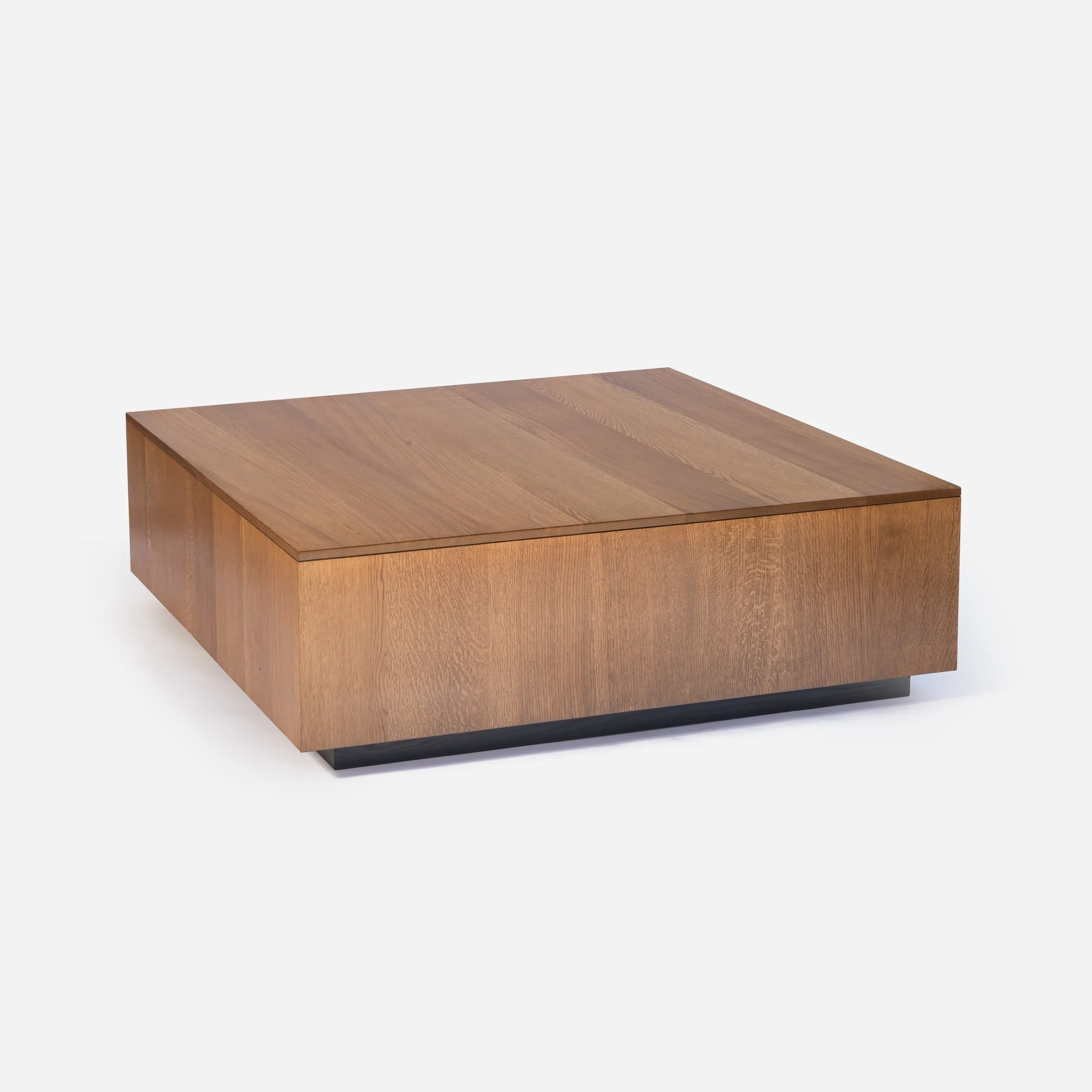 Handcrafted Strata Coffee Table made from solid white oak with light brown stain and bold black base, showcasing natural wood grain with architectural design, made in Milwaukee.