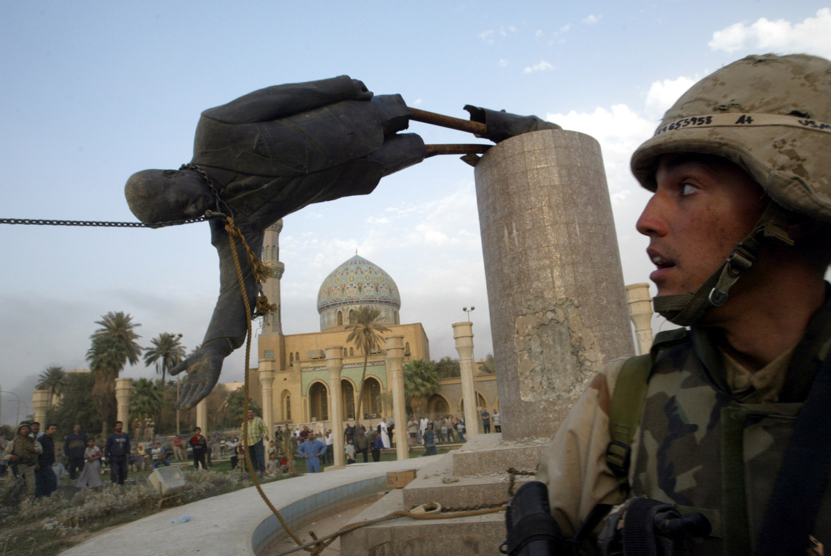 US militants stage media event, toppling Saddam Hussein statue in Firdaus Square (April 2003) 