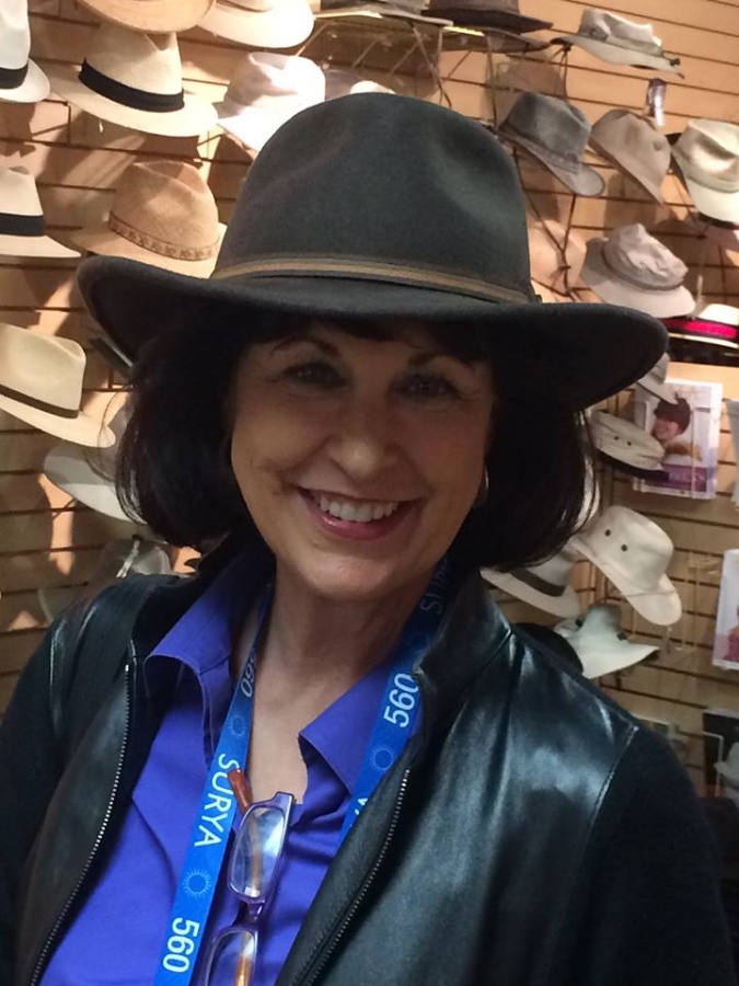 Martye trying on hats at Market