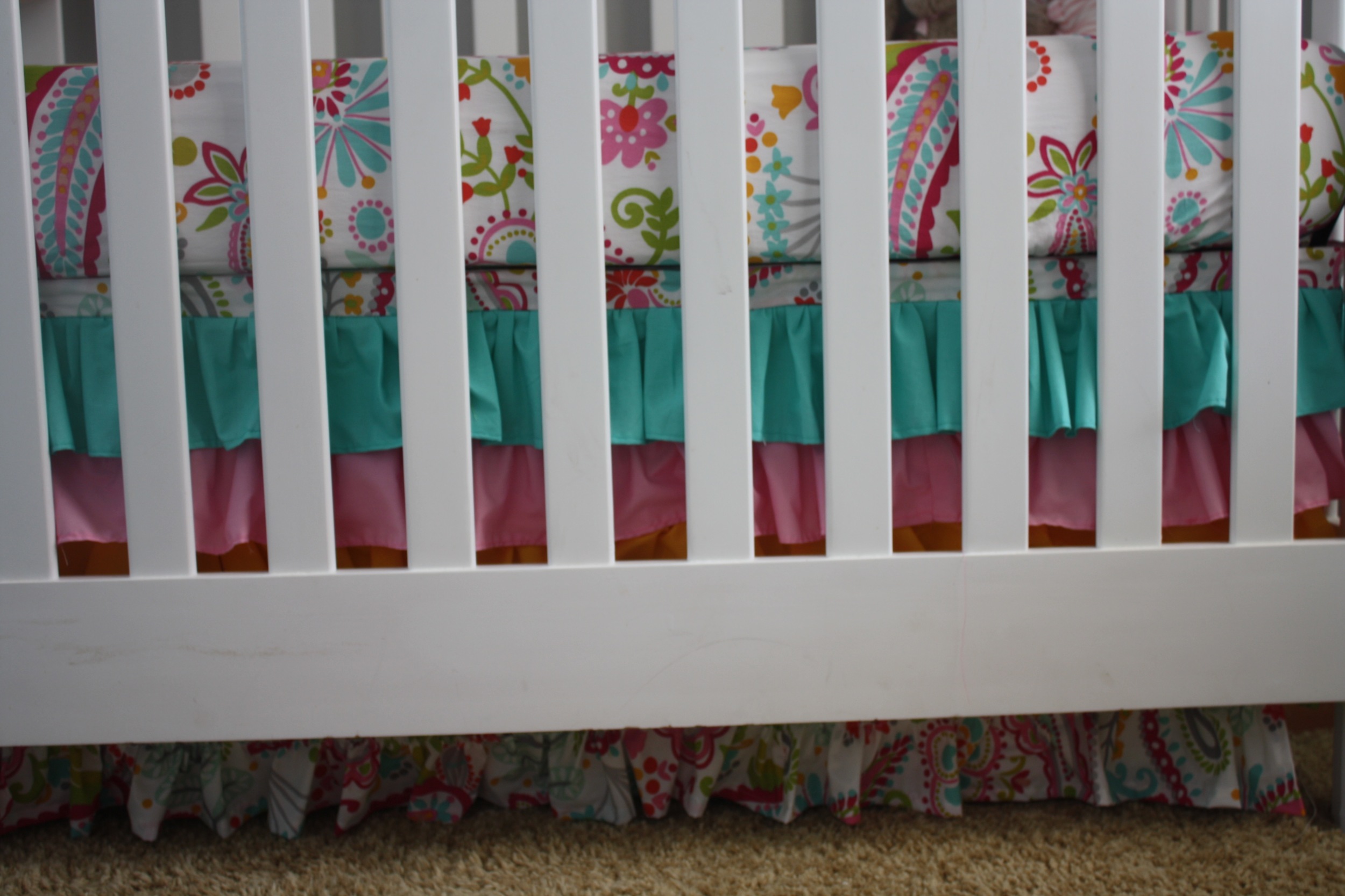 The crib skirt with ruffles. A little secret... they used Velcro to attach it to the bed frame so that they can remove it and made the bed skirt the right length as Cowgirl A grows and the bed gets lowered. This also saved them from having to make a 4th panel of crib skirt for the side along the wall!
