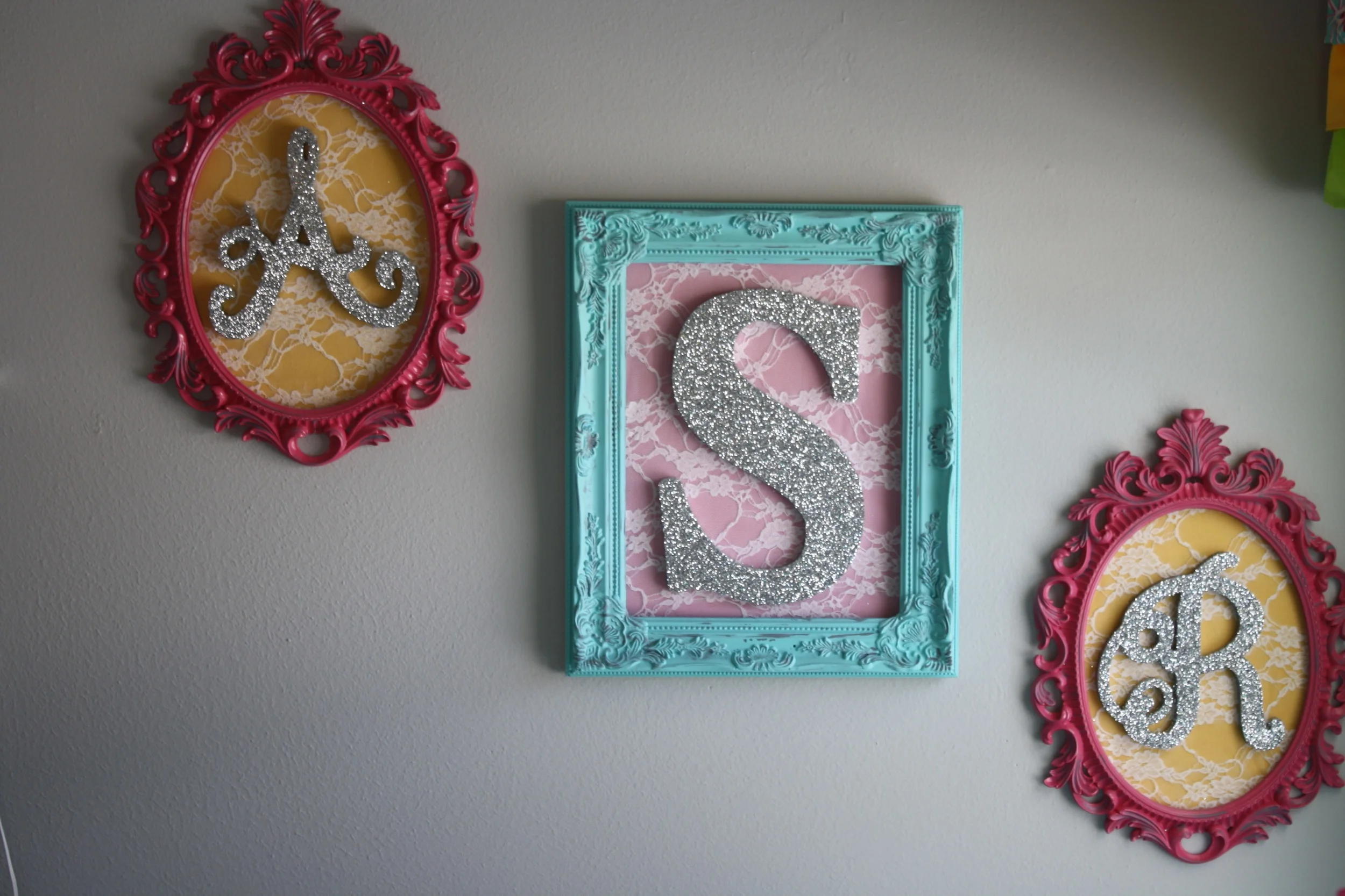 Holly had Trent paint these vintage frames and she glittered letters for Cowgirl A's initials. They kept the letters hidden until after she was born and they revealed her name. 