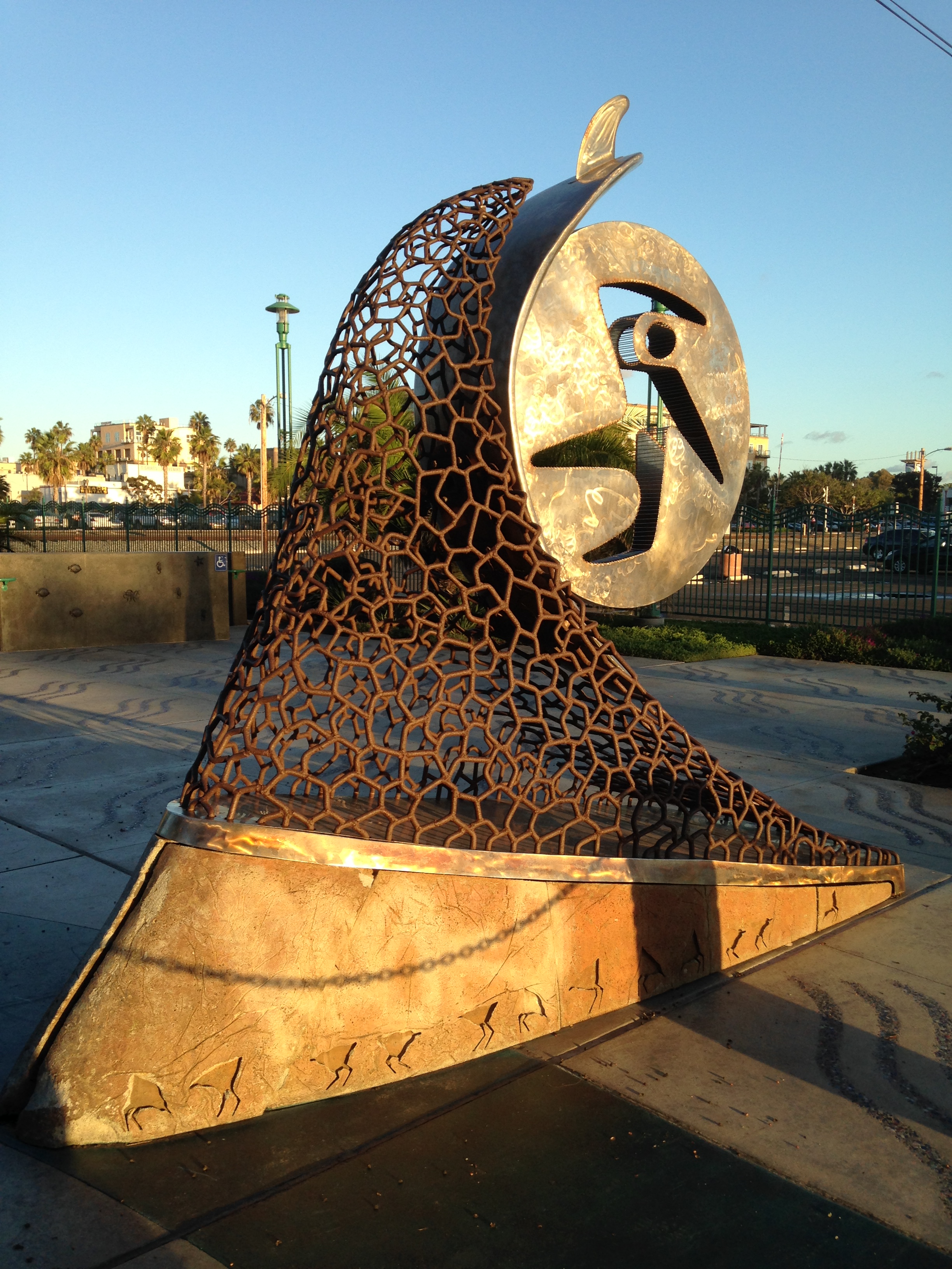 This surfing sculpture is located near the pier.