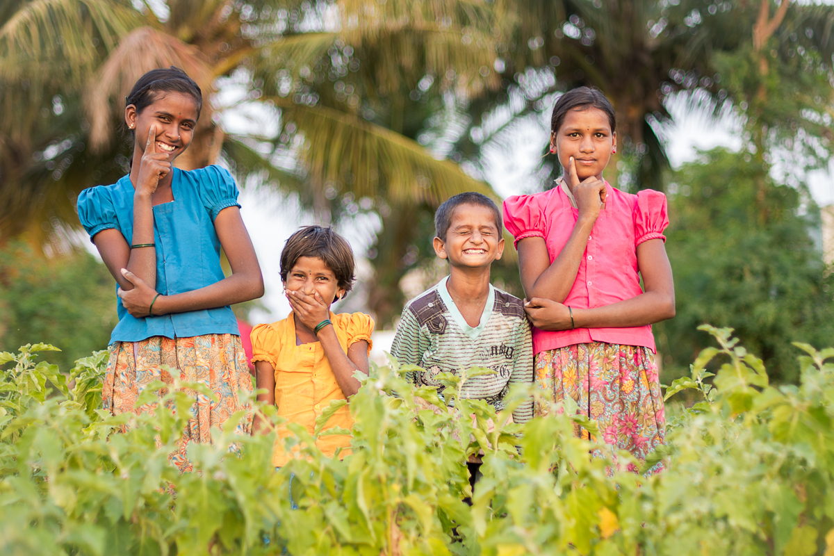 I heard my name (i.e. AMERICA!) being shouted near the school. The girl on the far left emerged from some thorn bushes. I'd last seen her in 2011, but I recognized her face. She tugged on my arm and led me down a ditch (the start of every great adventure). She had me wait while she carefully shifted a huge pile of logs, branches and thorns from the path (presumably to keep out unwanted water buffalo and unfriendly neighbors). She beckoned me to squeeze through the opening (I obviously tore my shirt) and led me through the cotton field where her mother and siblings were eager to greet me. Unfortunately, eager-to-greet is not the same as eager-to-have-portraits-taken, so it took me a while to crank out this group photo. I'm hoping to return at sunset to better capture the beauty of this field.