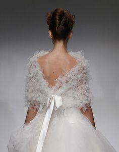  A soft cape accented with a satin bow.