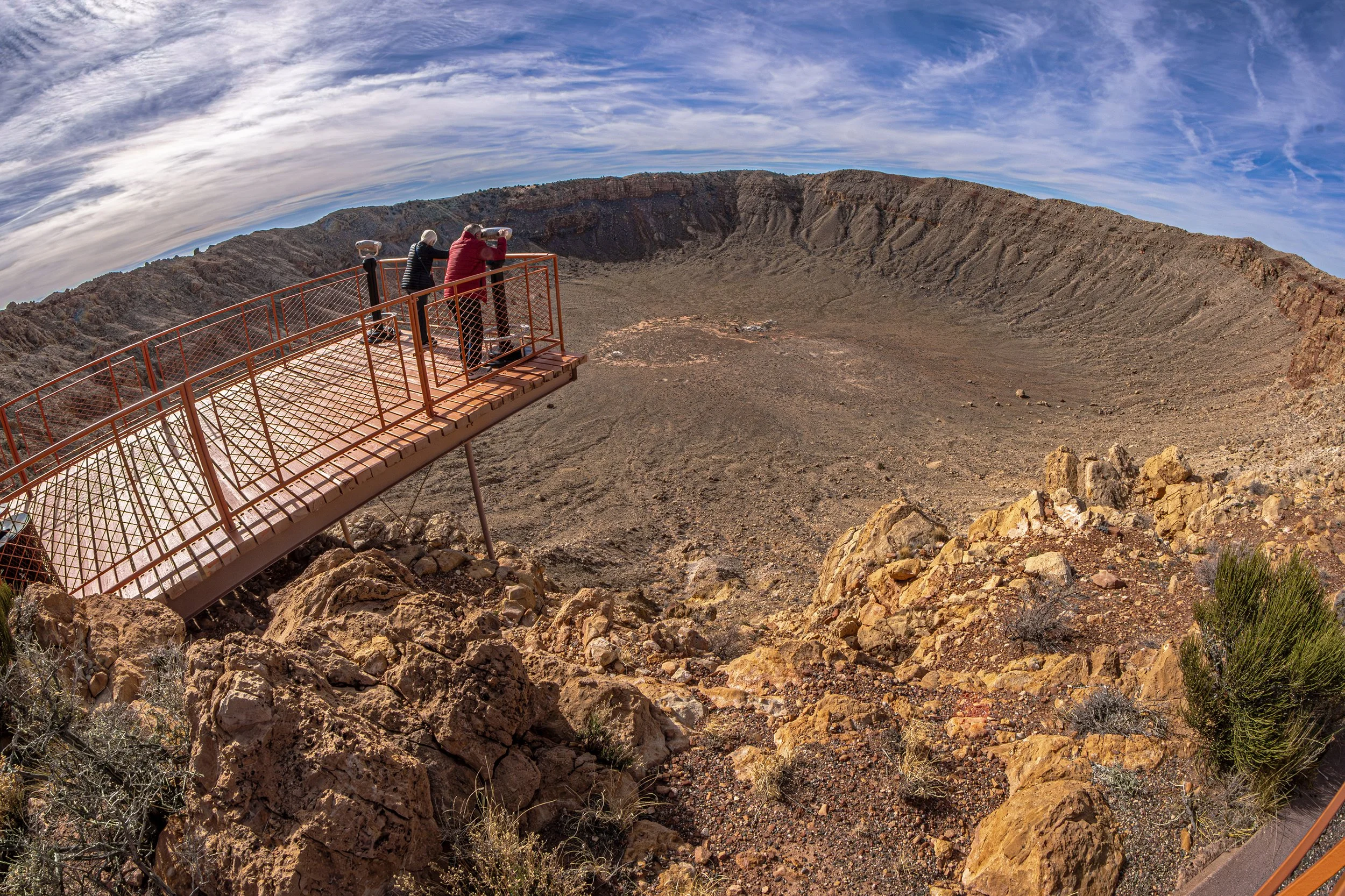  Tourists viewing from above a natural landmark known as Meteor Crater near Winslow, Arizona. 