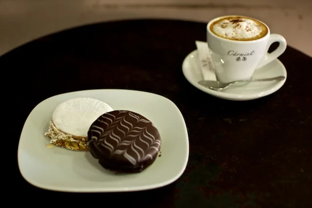Alfajores de dulce de leche con chocolate y azúcar glass con almendras laminadas