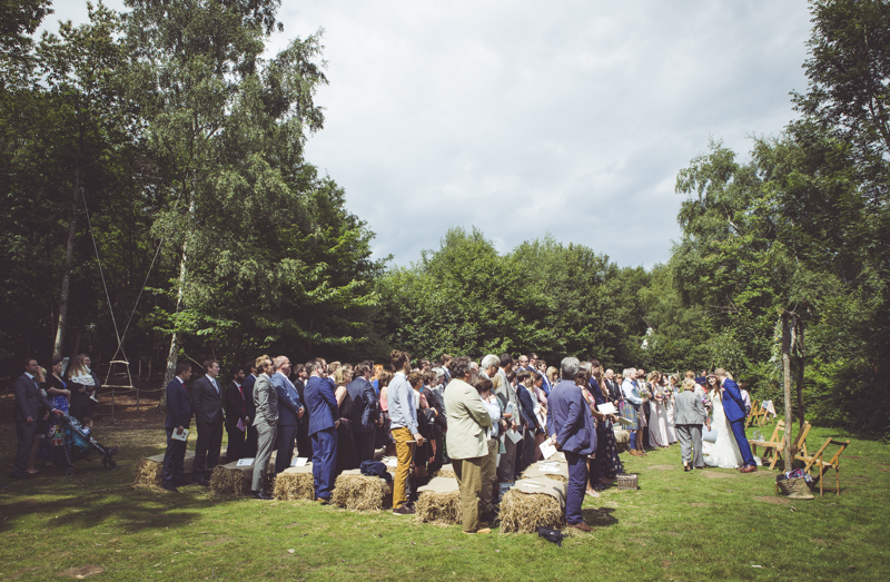 wedding guests seated on straw bales
