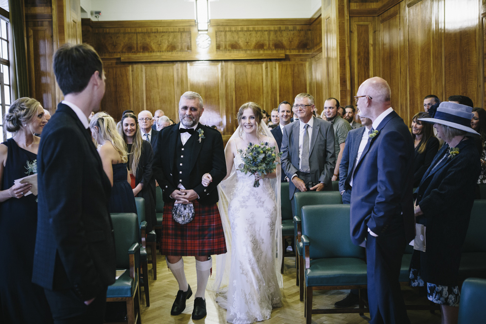 bride walks up the isle with father