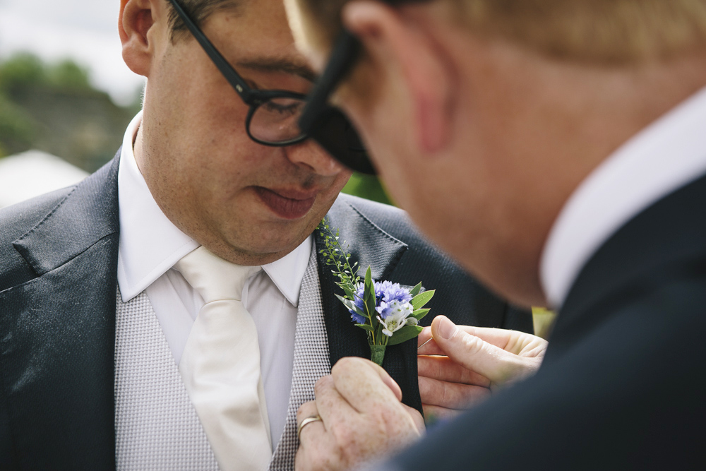 Bestman adjusting Olly's buttonhole