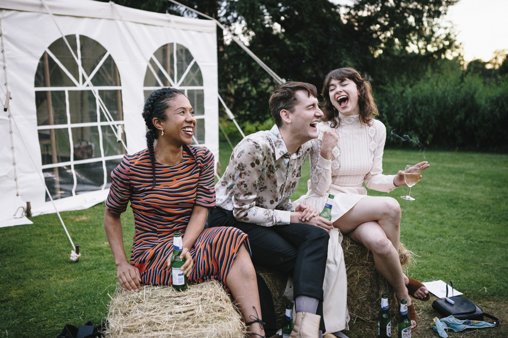 guests sitting on hay bales